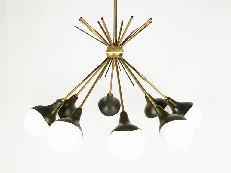 Vintage 8-lights chandelier in white opaline glass, brass and anodized aluminum. Very good vintage condition: oxidation patina as showed in pictures.