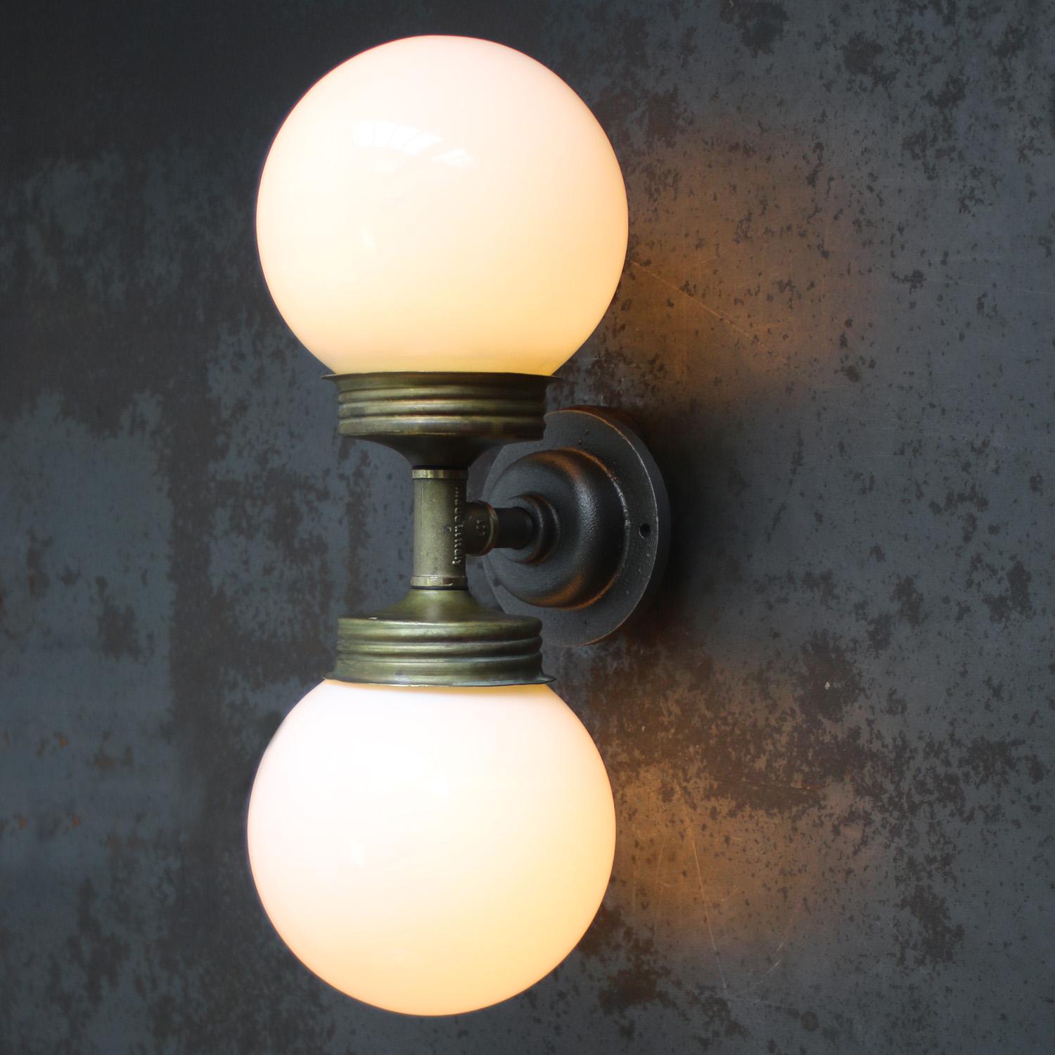 Double vintage brass and cast iron sconce wall lamp
Brass top with opaline glass 

Diameter cast iron wall piece 10.5 cm / 4”.
2 holes to secure.

Weight: 2.50 kg / 5.5 lb

Priced per individual item. All lamps have been made suitable by