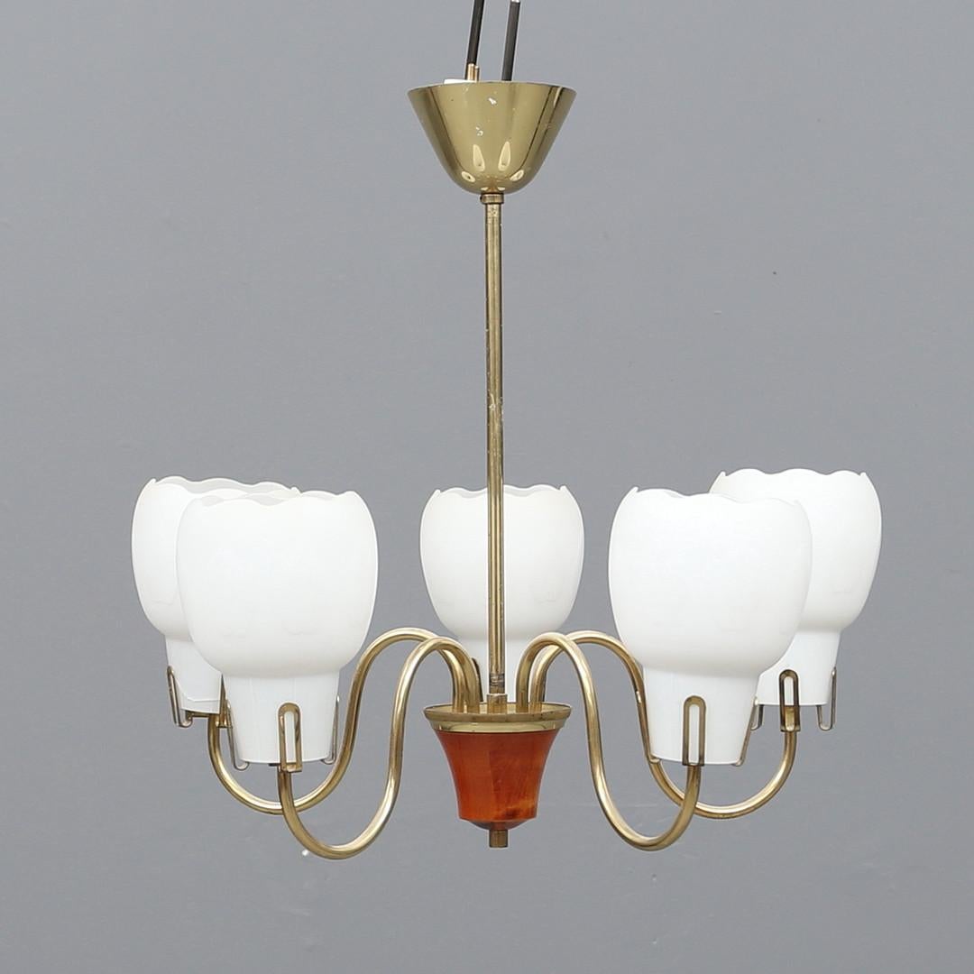 Brass construction with five opaline glass shades and fitted with E27 sockets. Made in Denmark in the 1960s.