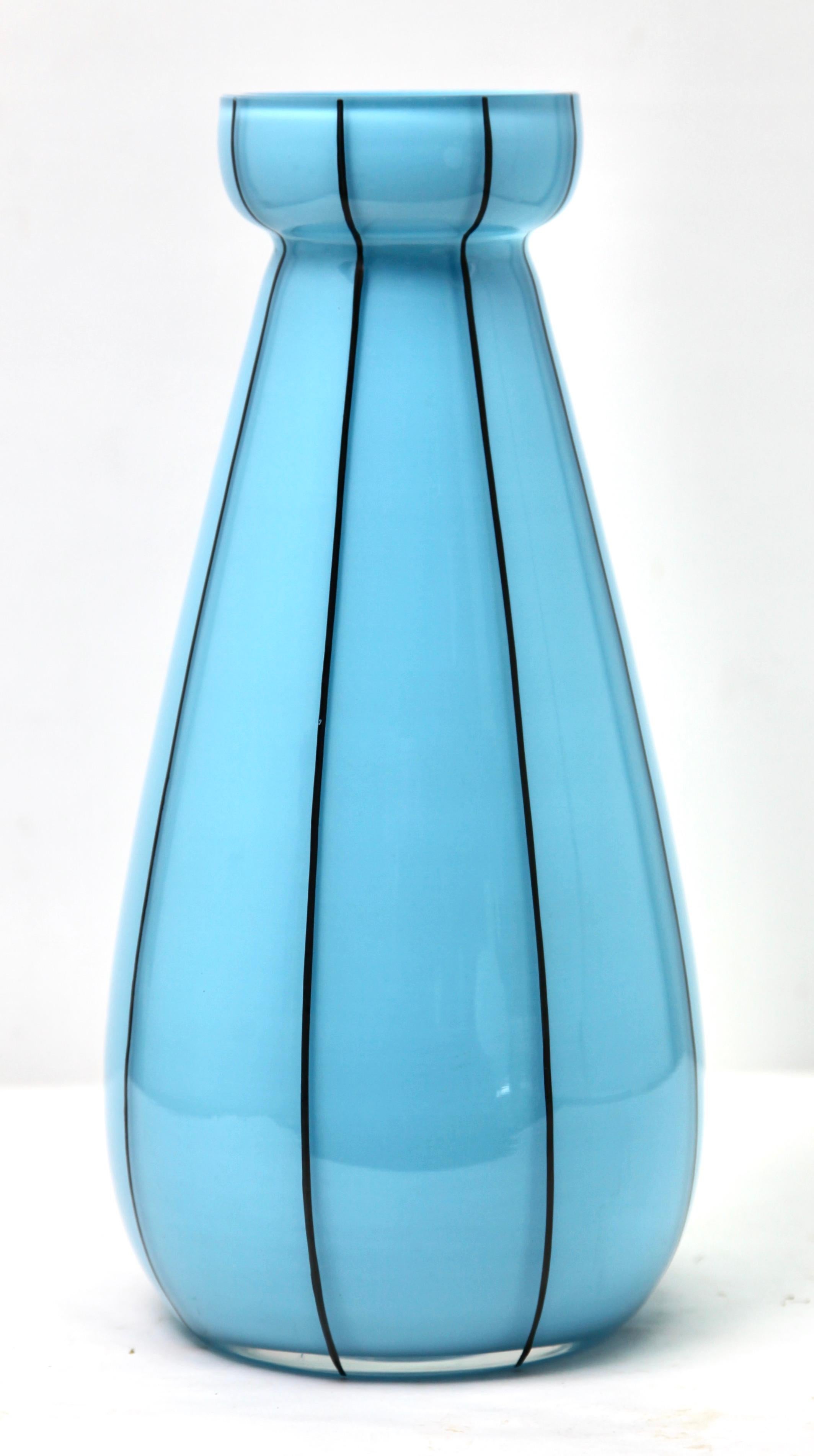 Opaline glass vases in baby blue, France, circa 1950

French opaline vase in opaque baby blue glass.
The hand painted decorated vase comes from circa 1950. 
This unusual color and design makes it much sought after.
 In good condition with such