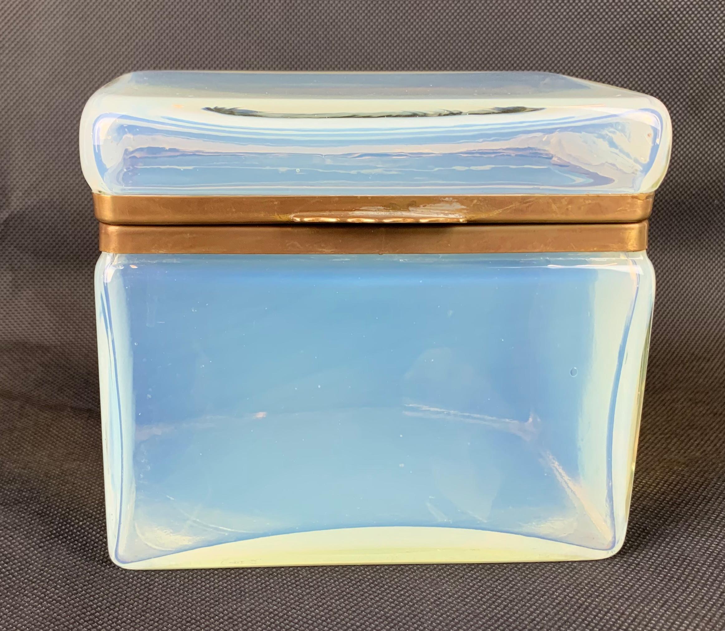 Unusual opalescent opaline glass hinged box. The frame is gilt metal. It is in perfect condition.