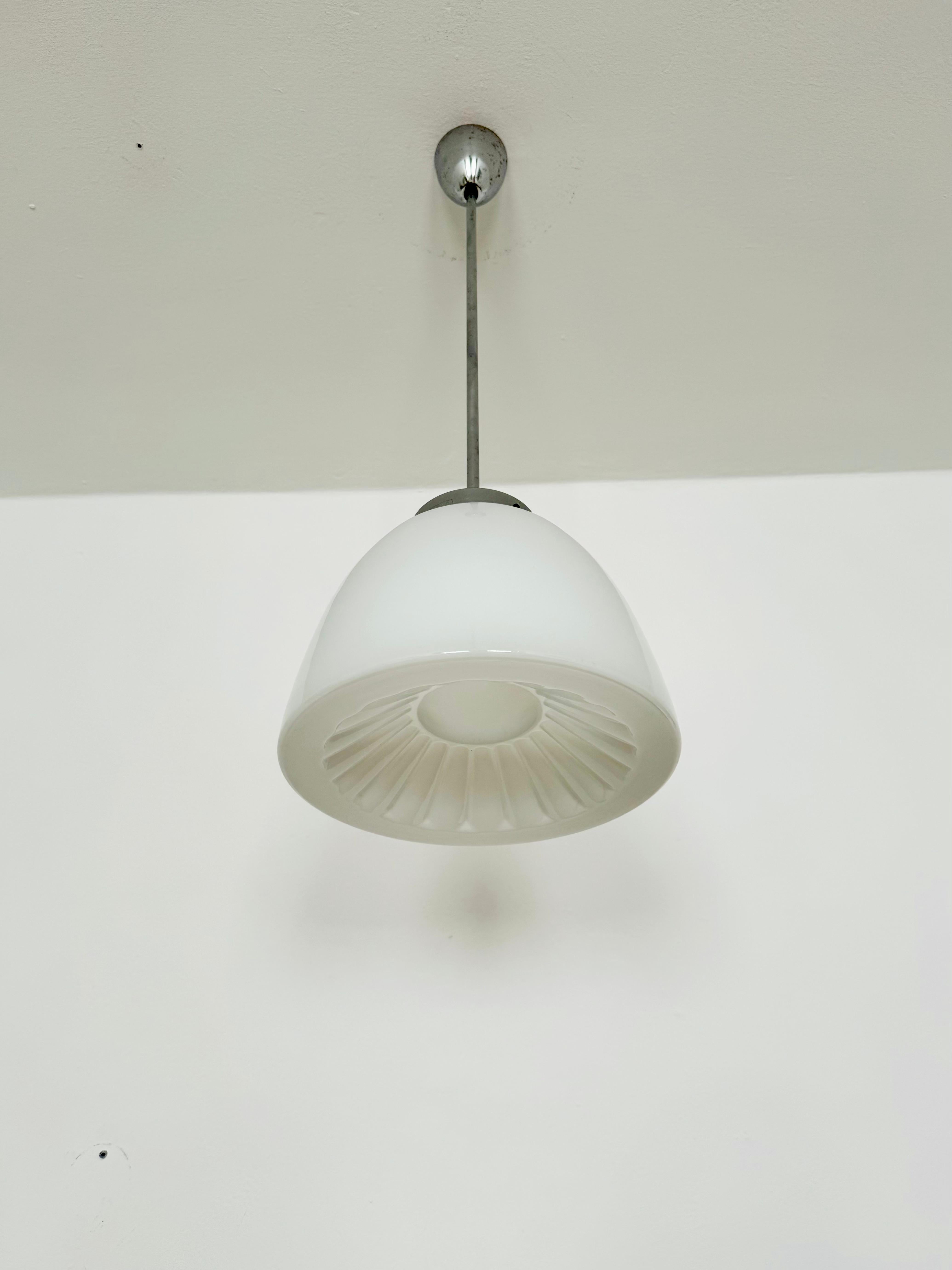Exceptionally beautiful ceiling lamp from the 1950s.
The lamp emits a very pleasant, warm light.
Wonderful shape and a timeless classic.

Manufacturer: Napako

Condition:

Very good vintage condition with slight signs of age-related wear.
The glass