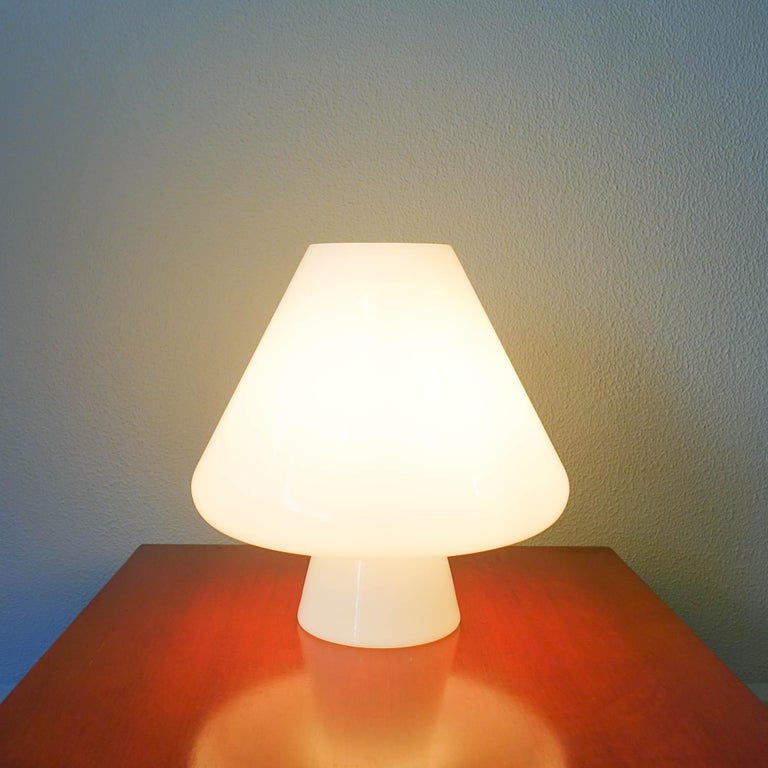 This table lamp was designed and produced by Venini, in Italy, during 1960's. It is just one piece, made in opaline glass with a mushroom shape. It is in the original and good condition.