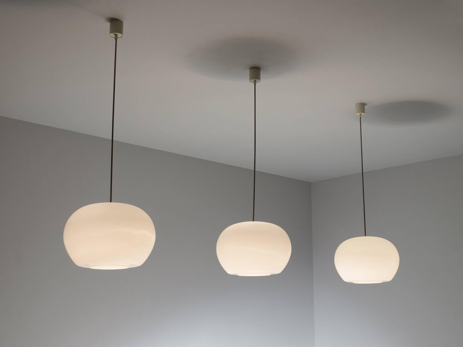 Large set of pendants in metal and opaline glass, Europe, 1970s.

Large set of pendants with opal shades. Simplistic design with a large globe shaped sphere. Due to the soft texture of the opaline glass,  these pendants will create a nice and warm