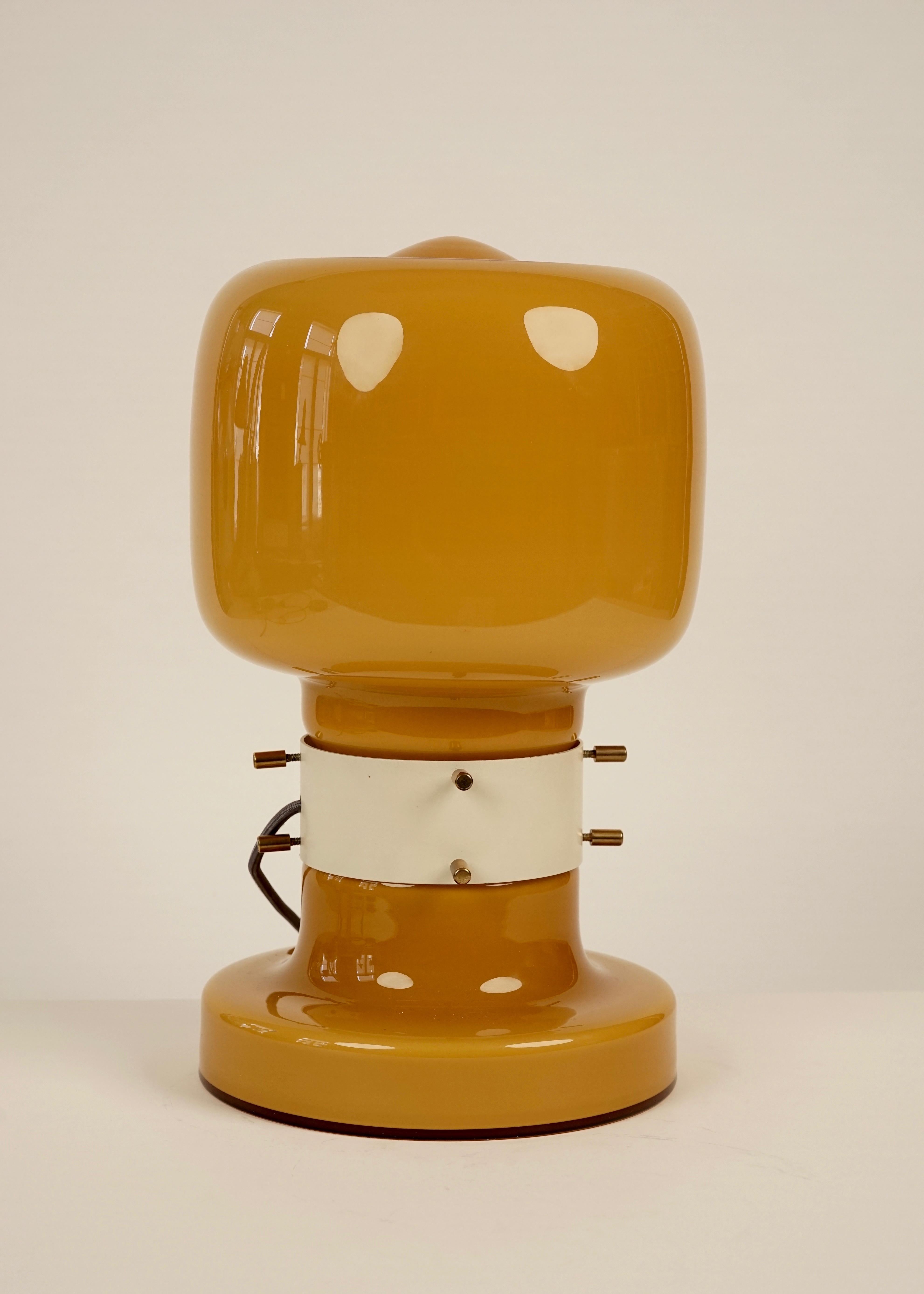 Table lamp is made from opaline glass with 8 styled brass screws and a metal sleeve.
An elegant design from the 1970s, produce in Czechoslovakia, from the company Sluzby mesta Ostavy, Zavod Kovoremesel in a small edition. The lamp have 2 lights.
 
