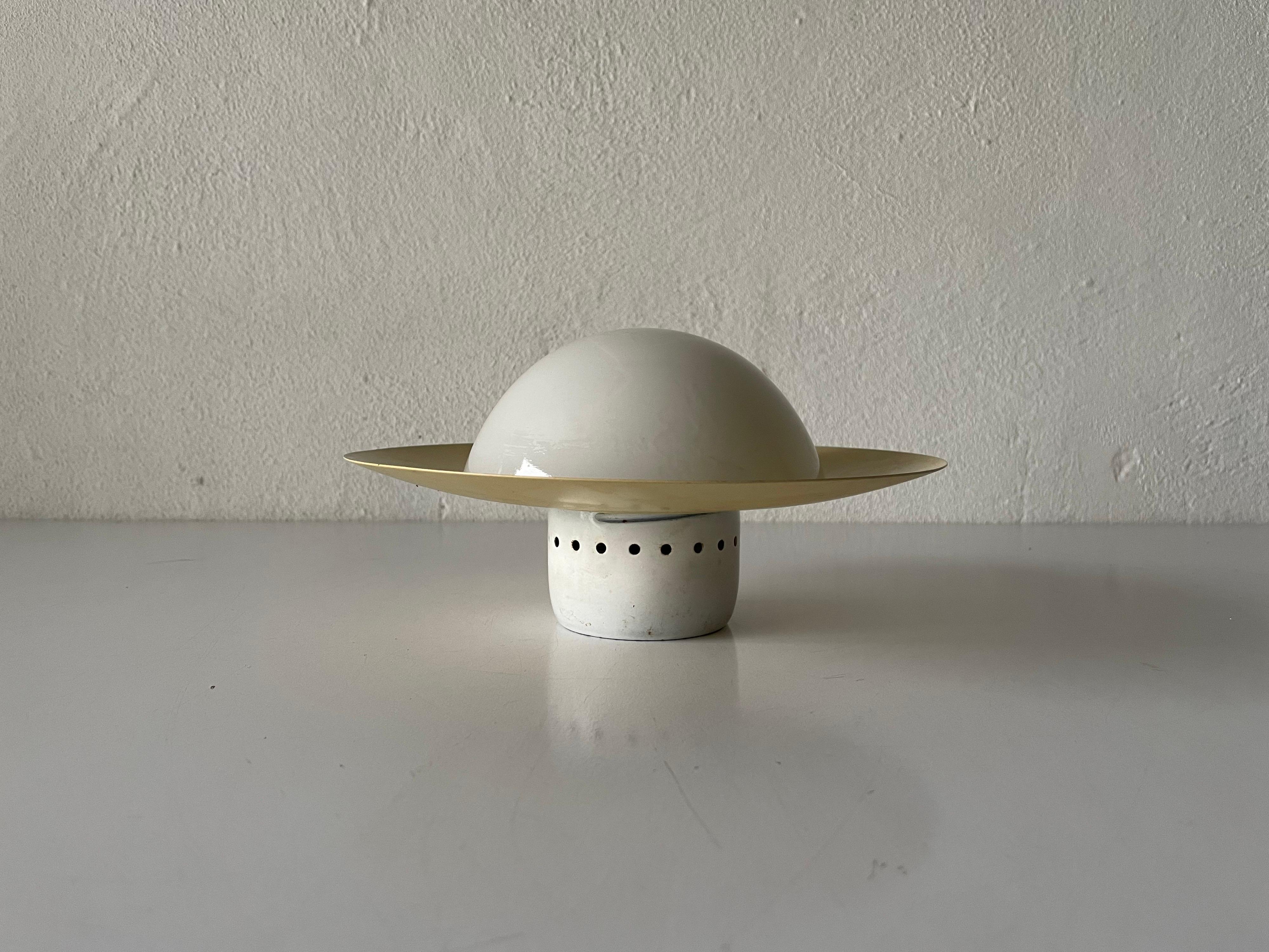 Very rare Ufo opaline glass yellow flush mount ceiling light by Kaiser Leuchten, 1960s, Germany

This lamp works with E14 light bulbs. 
Wired and suitable to use with 220V and 110V for all countries.

Measurements:
Diameter: 20 cm
Height: 11