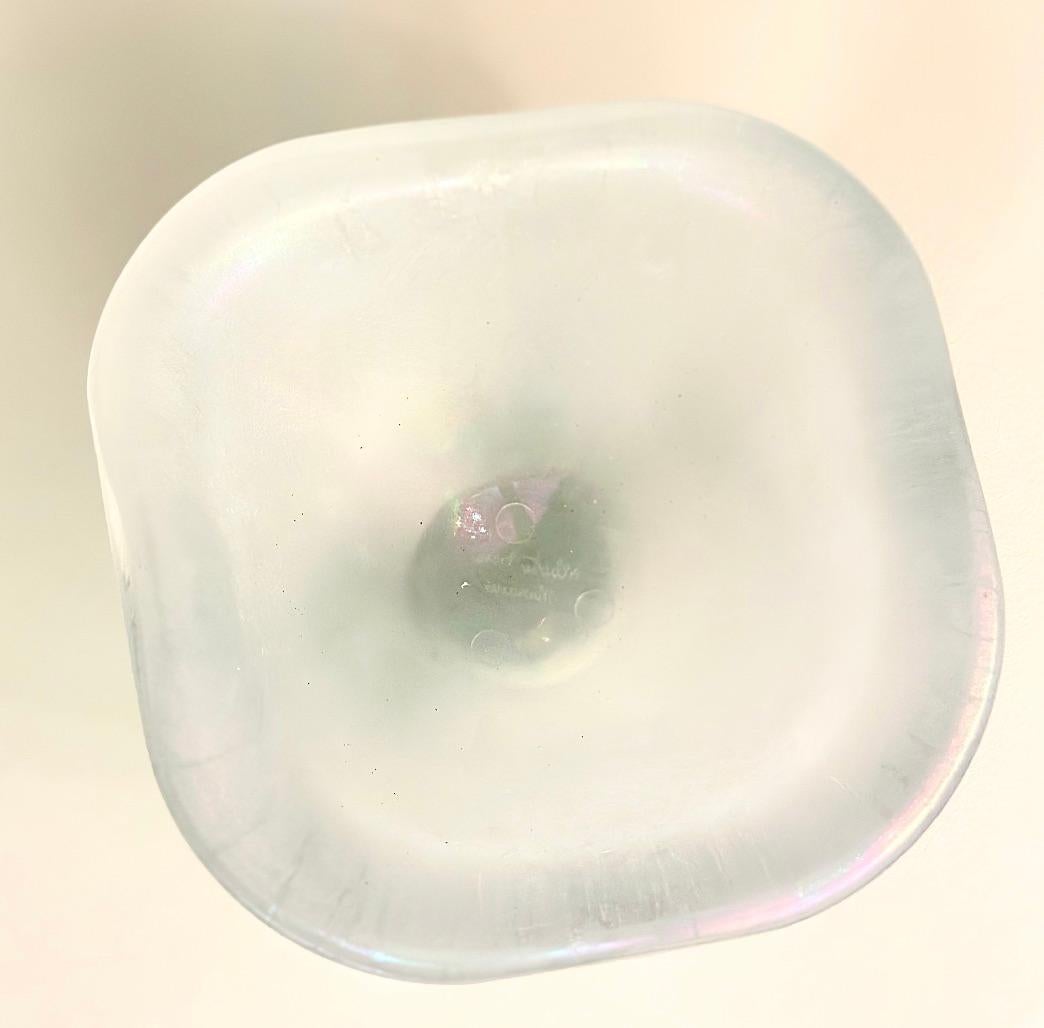 Handcrafted by skilled artisans of Murano, this glass bowl showcases the vibrant colors and craftsmanship that characterize the island's tradition of glassmaking. An exquisite opaline with shimmering pearl-like iridescence, this bowl adds a touch of