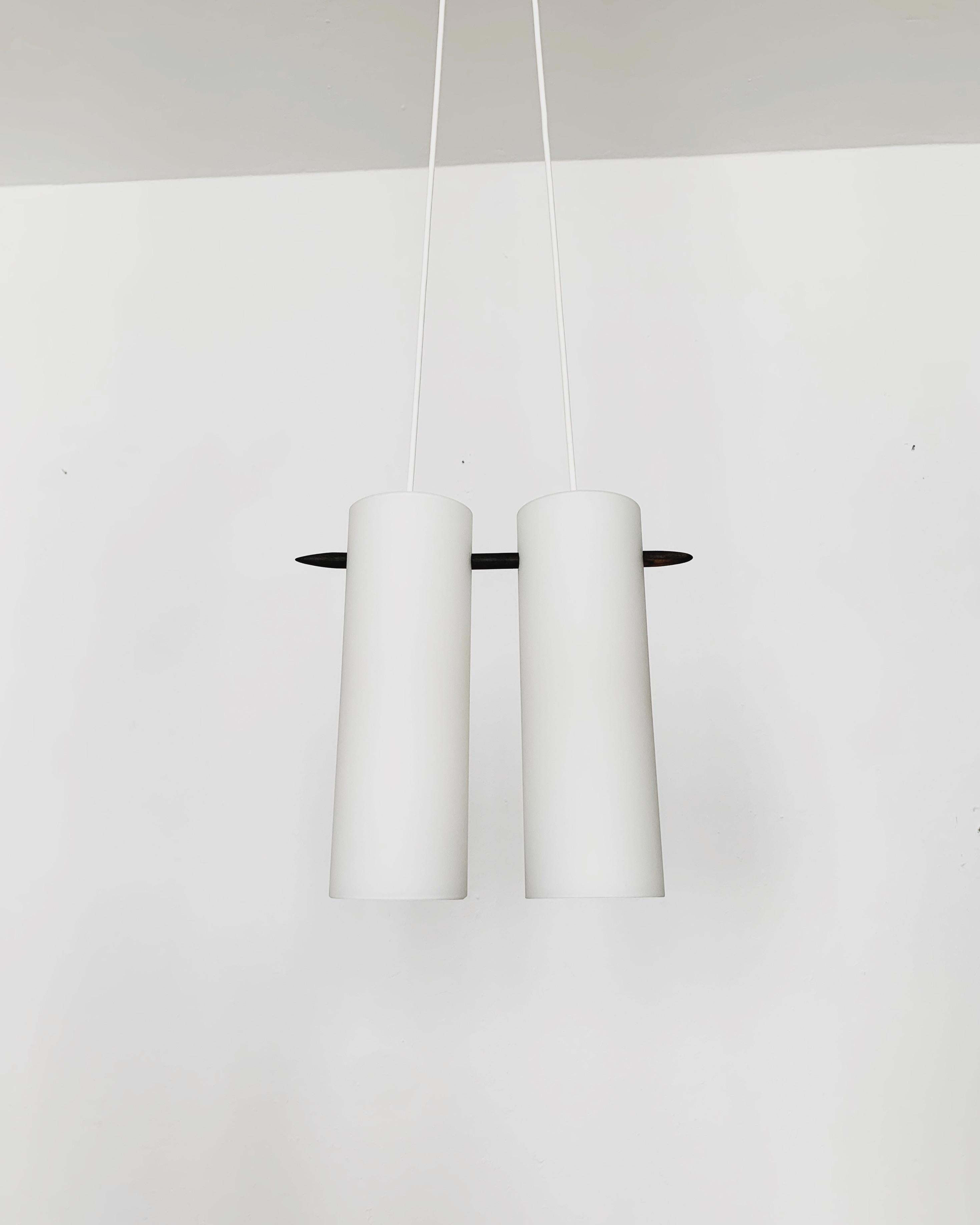 Wonderful Swedish opal glass pendant lamp from the 1960s.
Great and exceptionally minimalistic design with a fantastically elegant look.
Very nice details like the ebonized stick.

Manufacturer: Luxus
Design: Uno and Östen