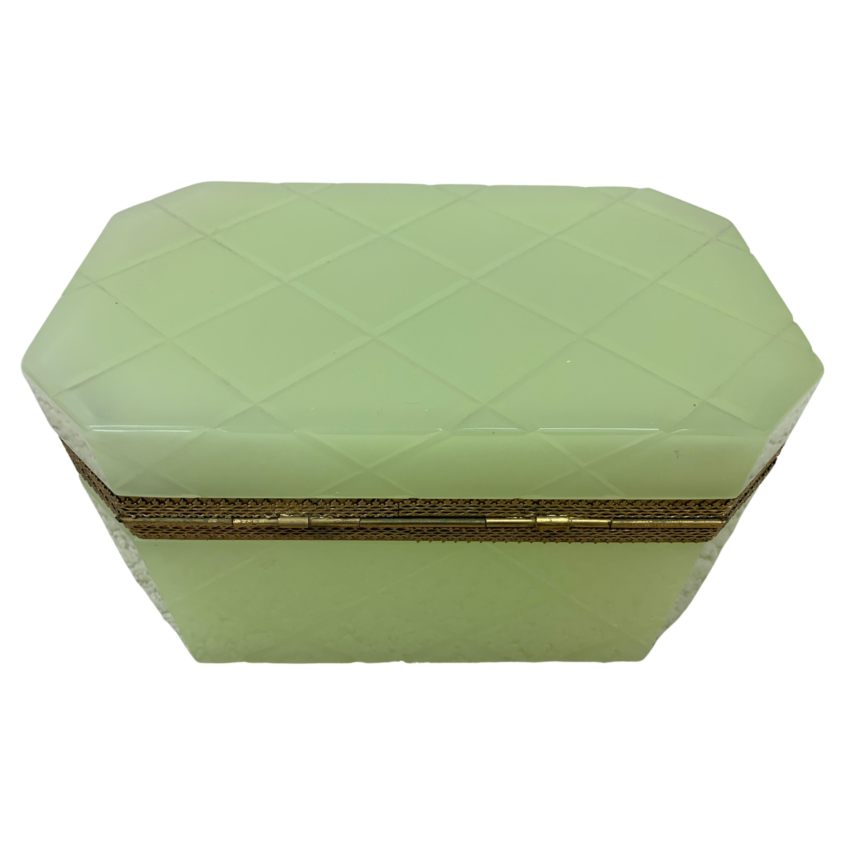 Opaline bright lime green box with hinged lid and a gorgeous gilt bronze motif. This stunning box is accented with a cross diamond pattern. Circa 1850. Dimensions 9 inches wide, 5.5 inches deep and 5 inches high.