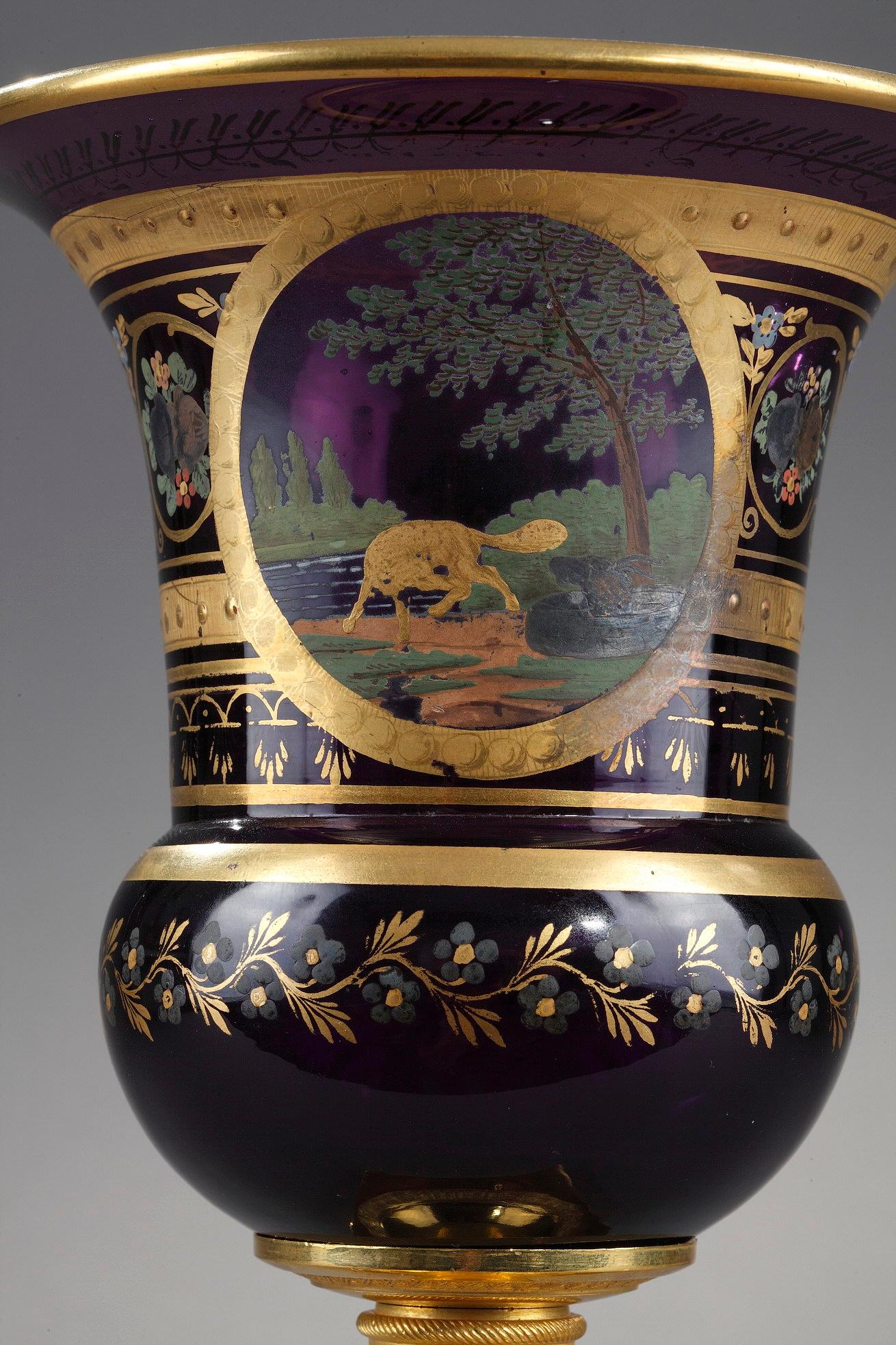 A very elegant amethyst Medicis vase. It consist of a gilded bronze pedestal base, adorned finely sculpted with foliage.The base supports the opaline which is decorated with banding, friezes of palmettes, a garland of blue flowers, and multicolored