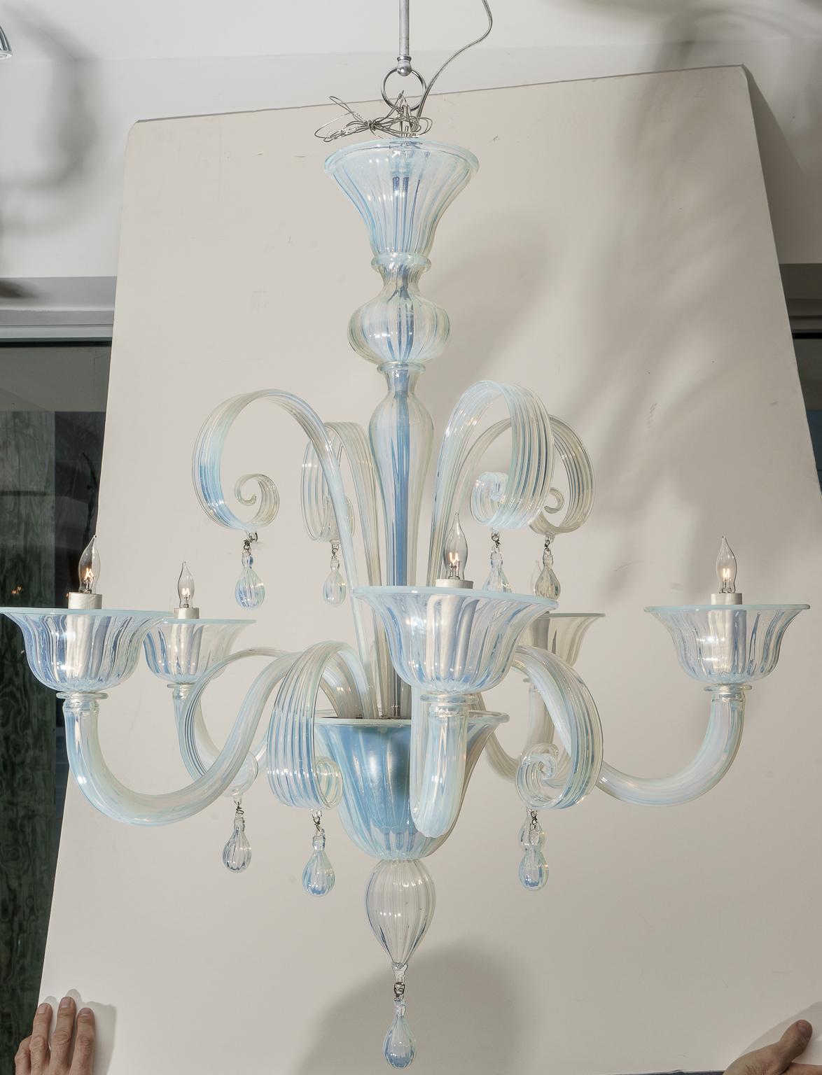 This romantic and stylish opaline glass Murano chandelier was acquired from a Palm Beach estate and it dates to the later part of the 20th century.

Note: Dimensions of the body of the chandelier are 31.25