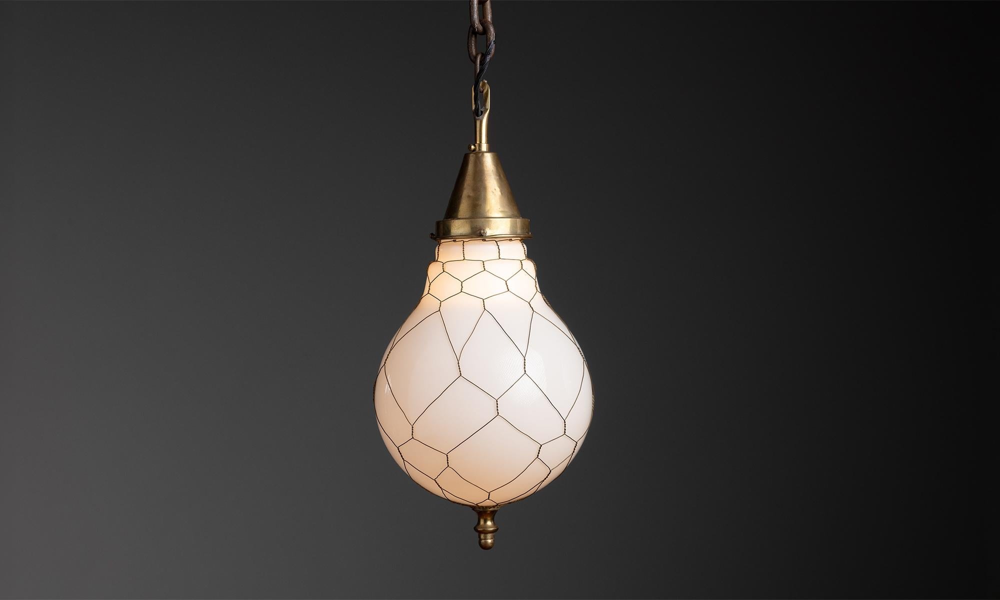 Opaline Pendant
England 1920
Opaline glass shade with metal netting and brass fixture.
8