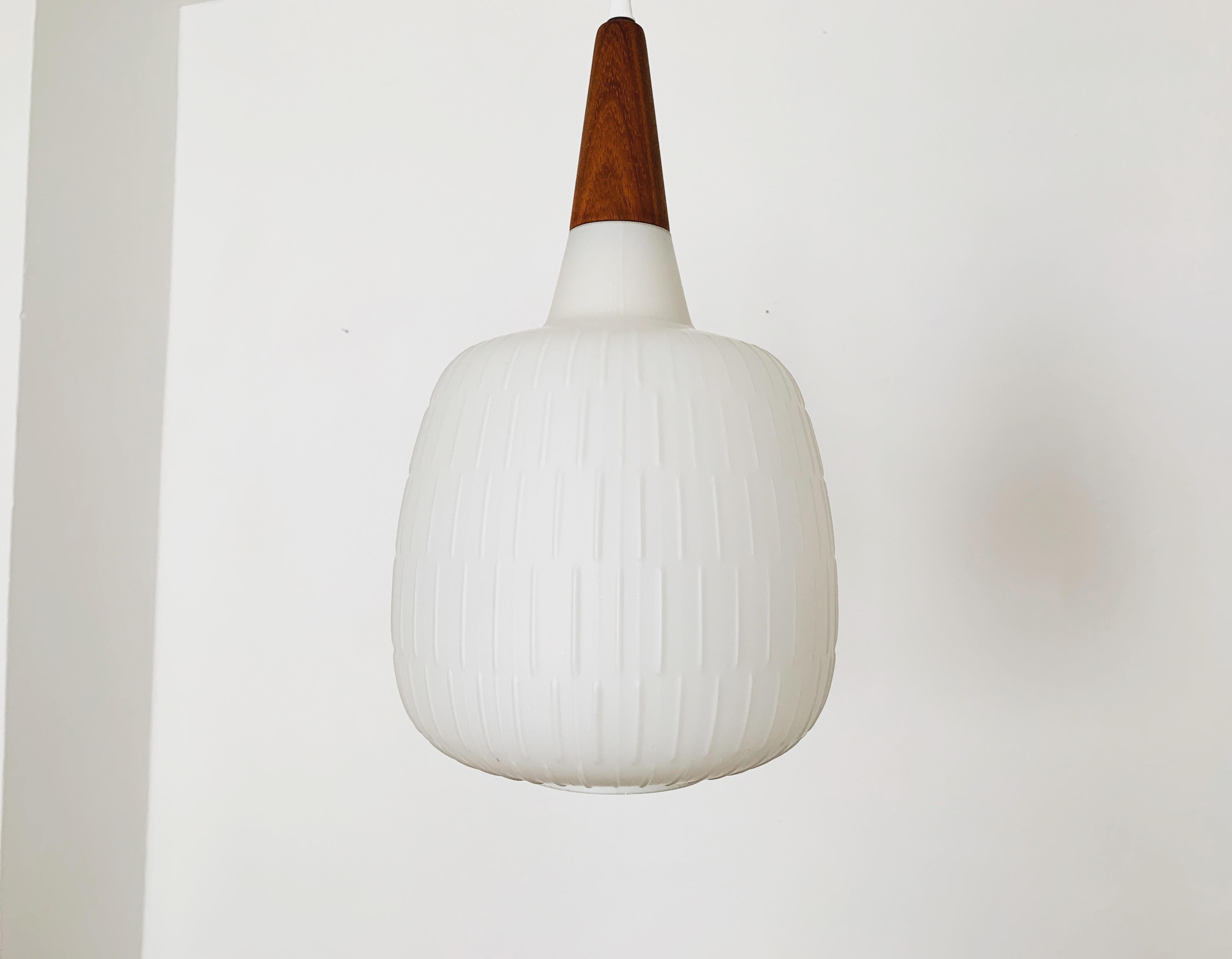 Wonderful opal glass pendant lamp from the 1950s. 
Extremely beautiful design and a real eye-catcher in every home.
Extremely beautiful lighting atmosphere with both direct and indirect light.

Manufacturer: Peill and Putzler 
Design: Aloys