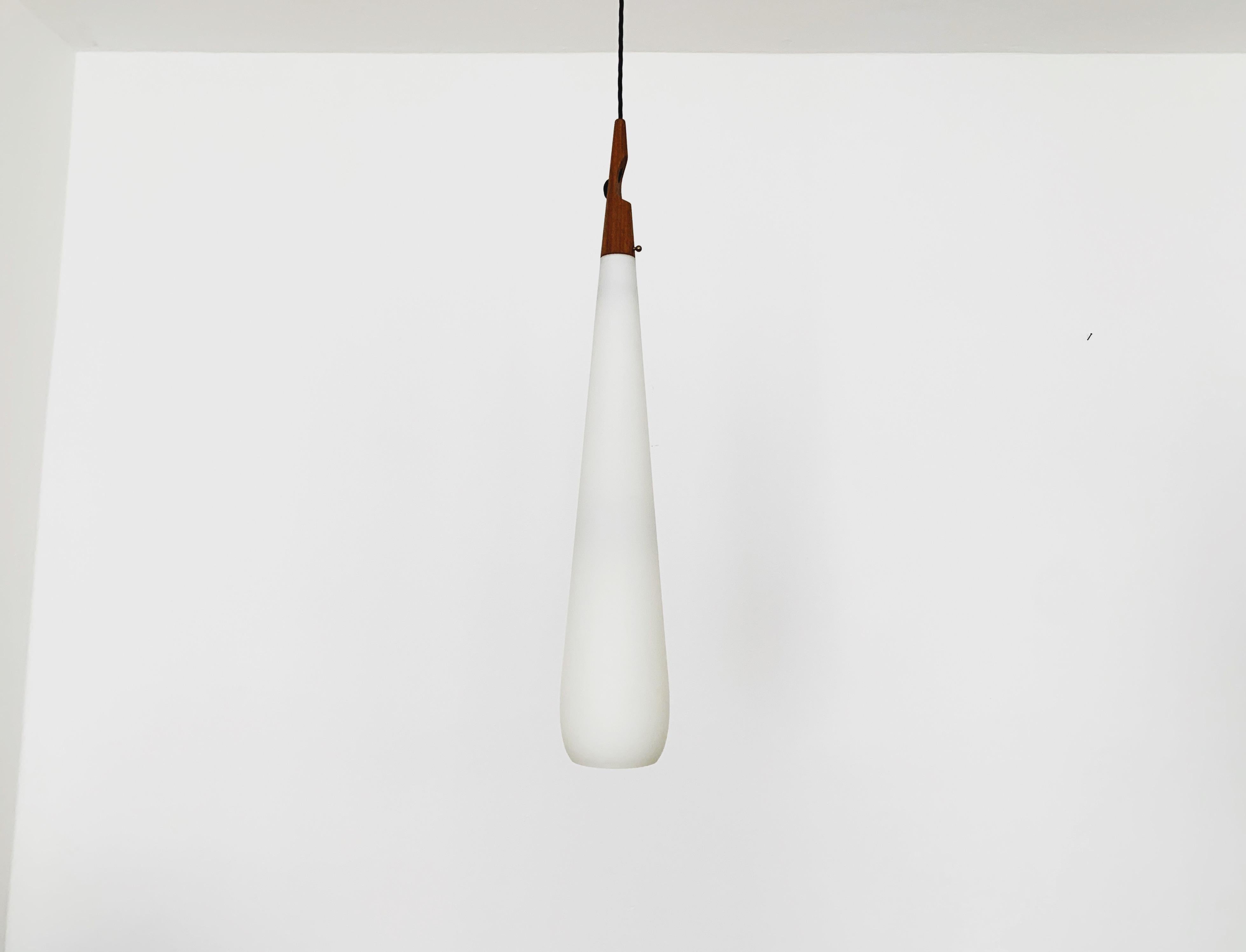 Extremely rare and beautiful Swedish opal glass pendant lamp from the 1960s.
Great and exceptionally minimalistic design with a fantastically elegant look.
Very nice teak details.

Design: Uno and Östen Kristiansson

Condition:

Very good