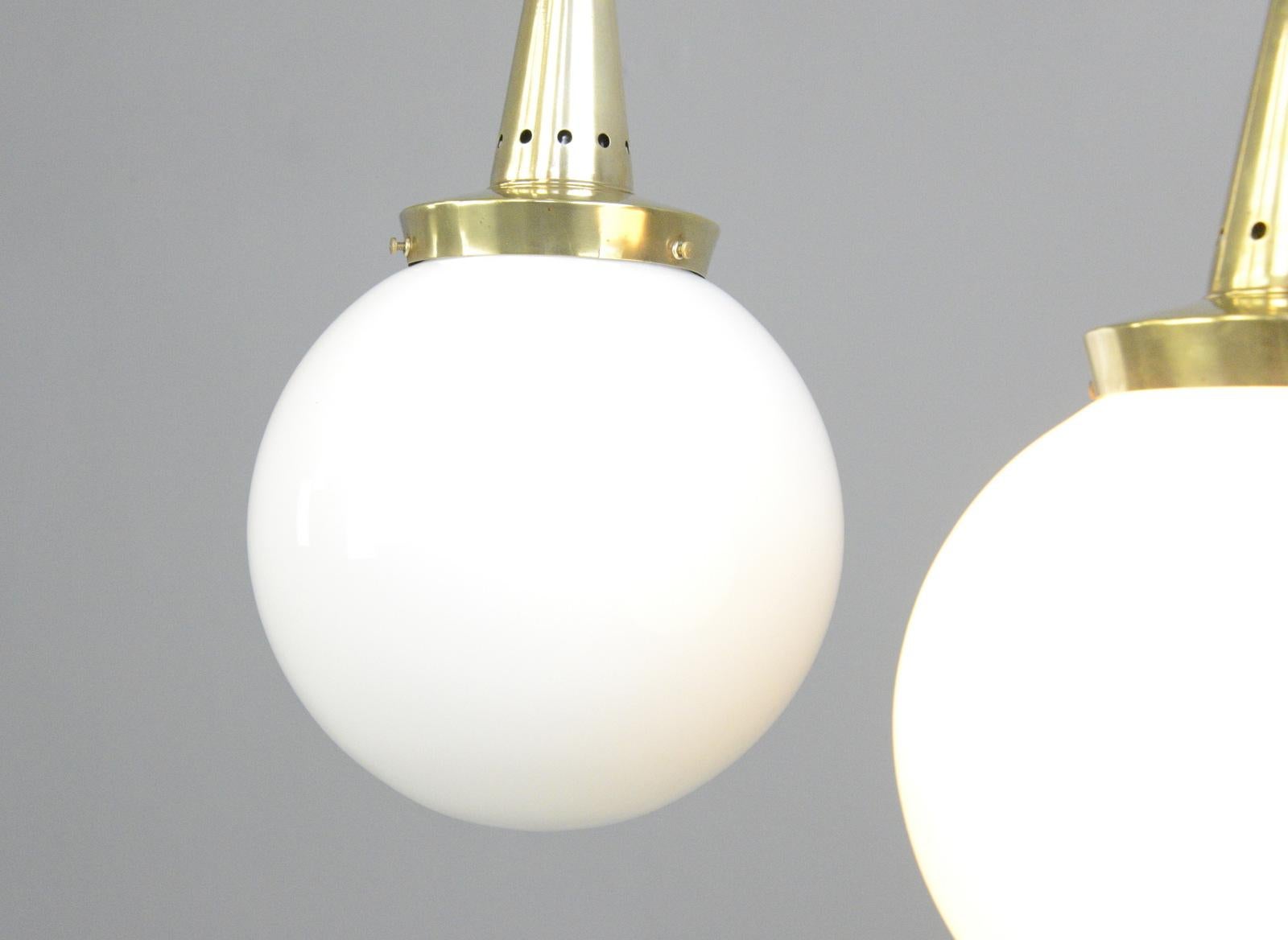 Opaline pendant lights by Marianne Brandt for Schwintzer & Gräff

- Price is per light
- Opaline glass globes
- Conical brass galleries
- Takes E27 fitting bulbs
- Comes with 100cm of brass chain and cable
- Comes with ceiling rose
-