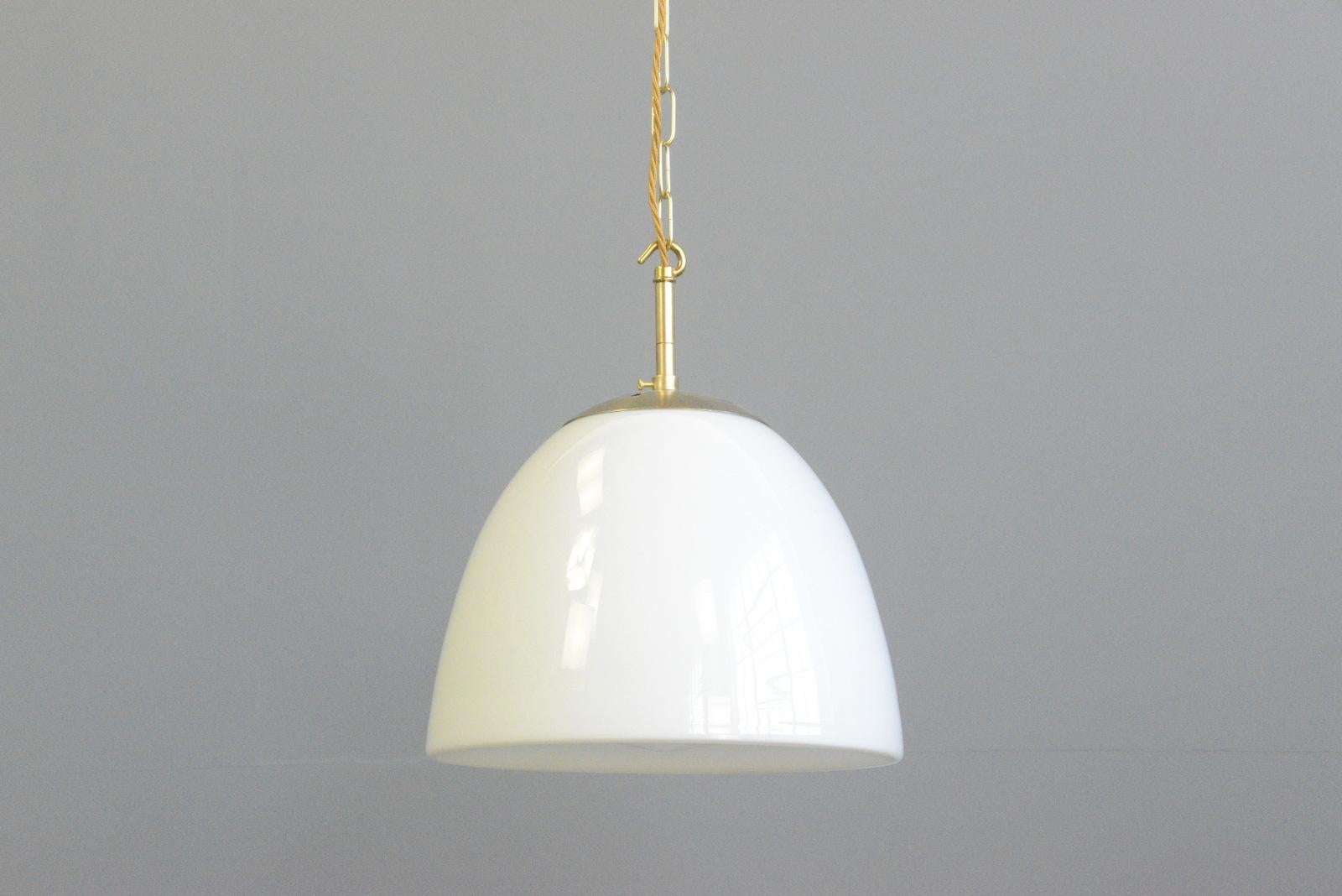 Opaline pendant lights by Vilhelm Lauritzen Circa 1950s

- Opaline glass with a slight concave and point on the underneath
- Brass monks cap top
- Takes E27 fitting bulbs
- Comes with 100cm of black cable
- Designed by Vilhelm Lauritzen
-