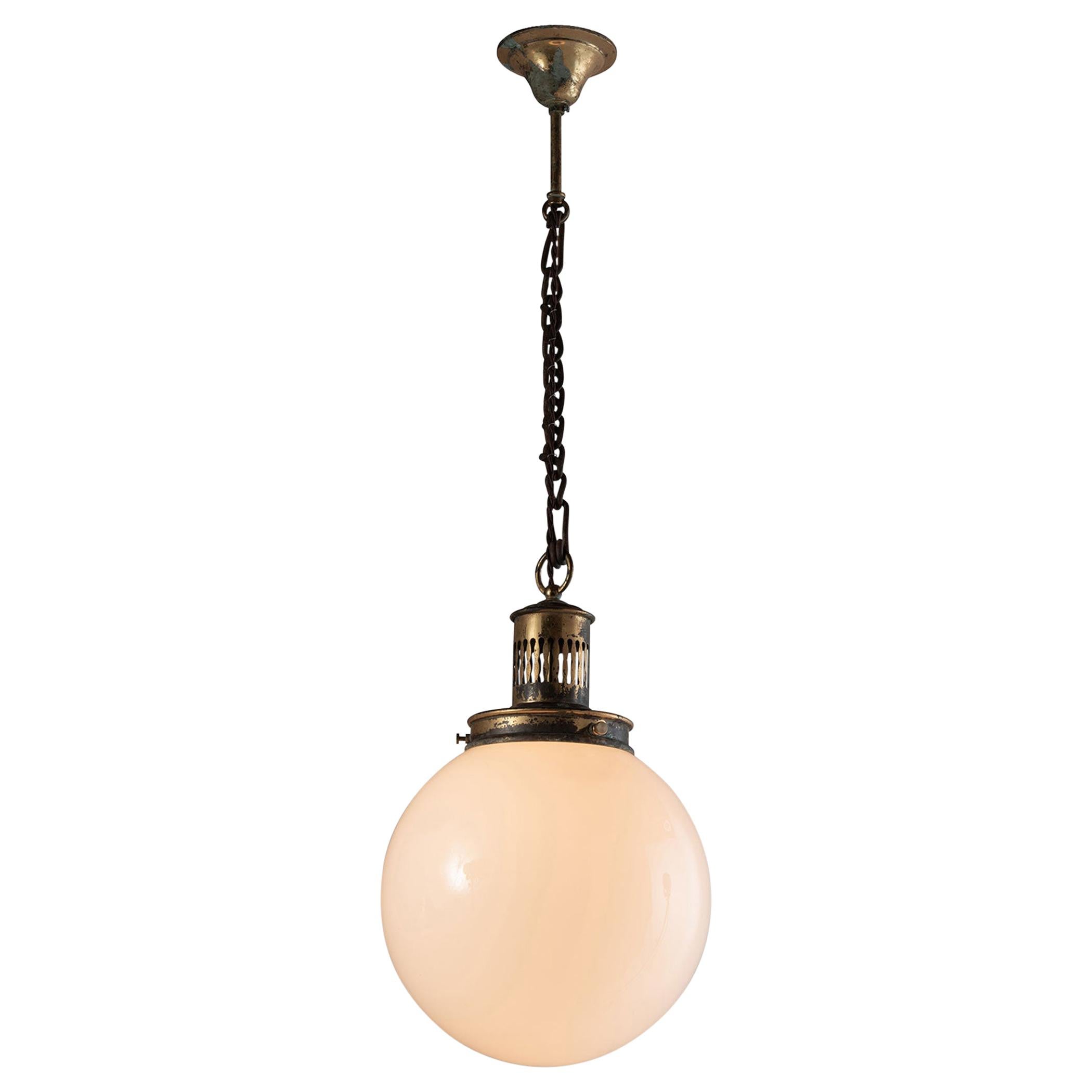 Opaline globe pendant with brass fitter and canopy.

 