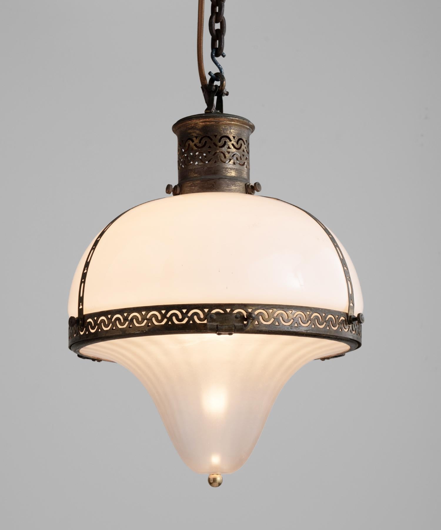Opaline teardrop pendant, France, circa 1930.

Opaline and frosted glass shades with ornate brass cage and fitter.