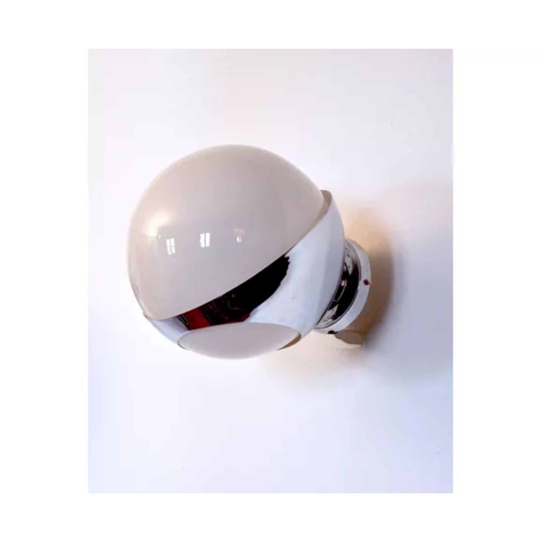 Large wall lamp made in italy in the 1960s. White opaline glass sphere inserted in a chromed aluminum support fixed to the wall. Retro-futuristic design reminiscent of the 