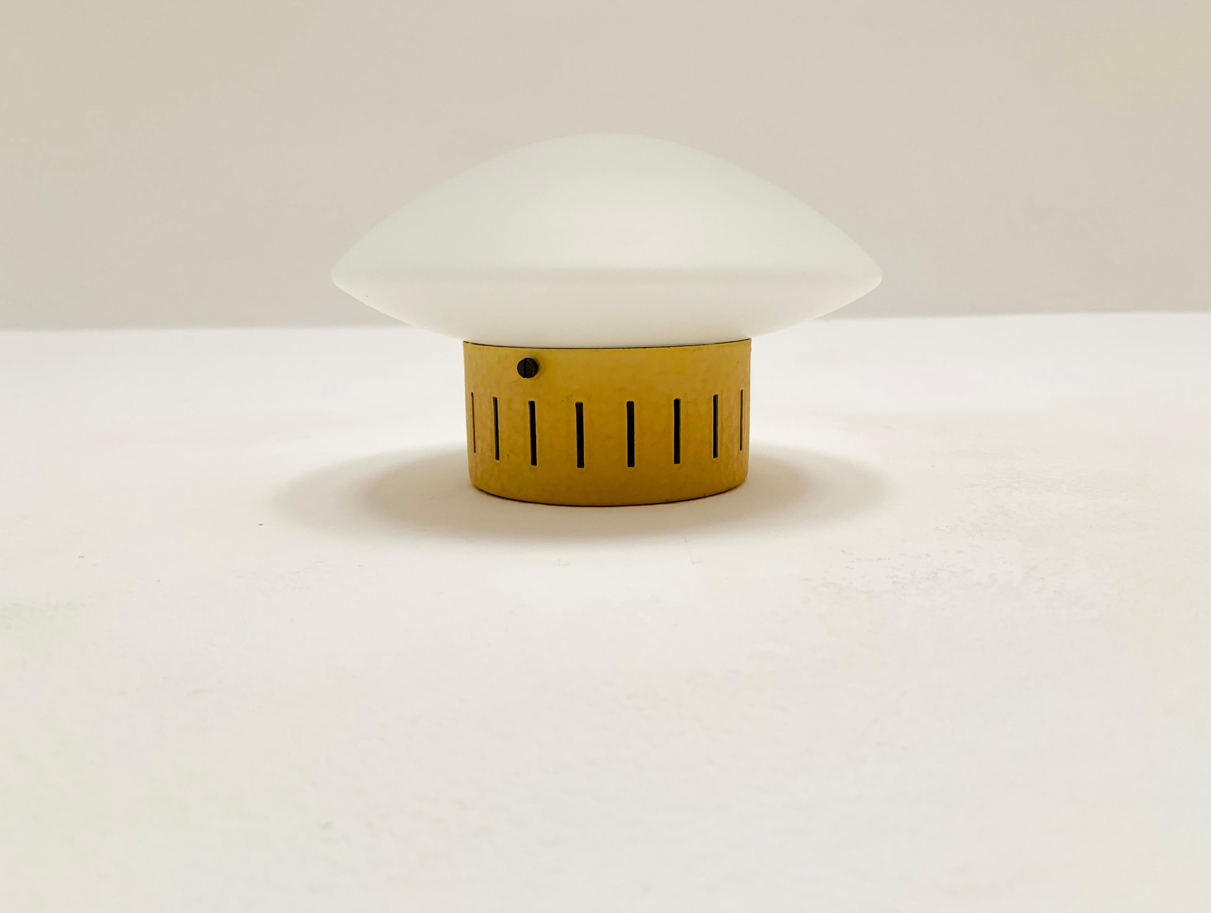 Very nice opal glass wall lamp or ceiling lamp from the 1950s.
Very elegant and classic shape.
The slits in the yellow holder create a wonderful play of light.

Condition:

Very good vintage condition with slight signs of wear consistent with