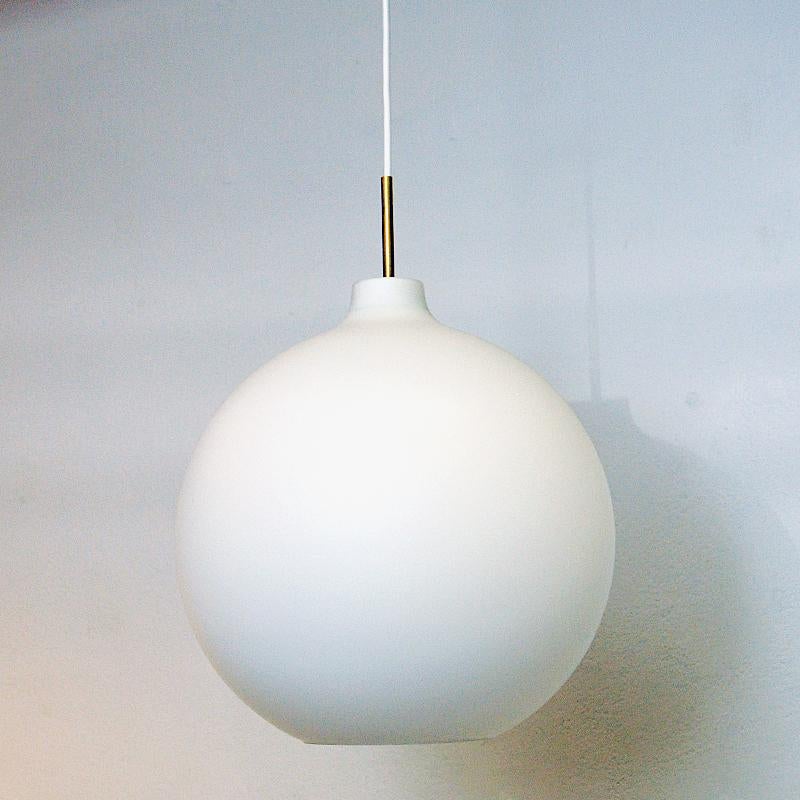 Classic frosted opaline glass pendant Satellite by Vilhelm Wohlert for Louis Poulsen 1960s, Denmark. Wohlert designed the pendant lamp in three sizes to make it suitable for different spaces. The idea was that the lamp should be easy to maintain and