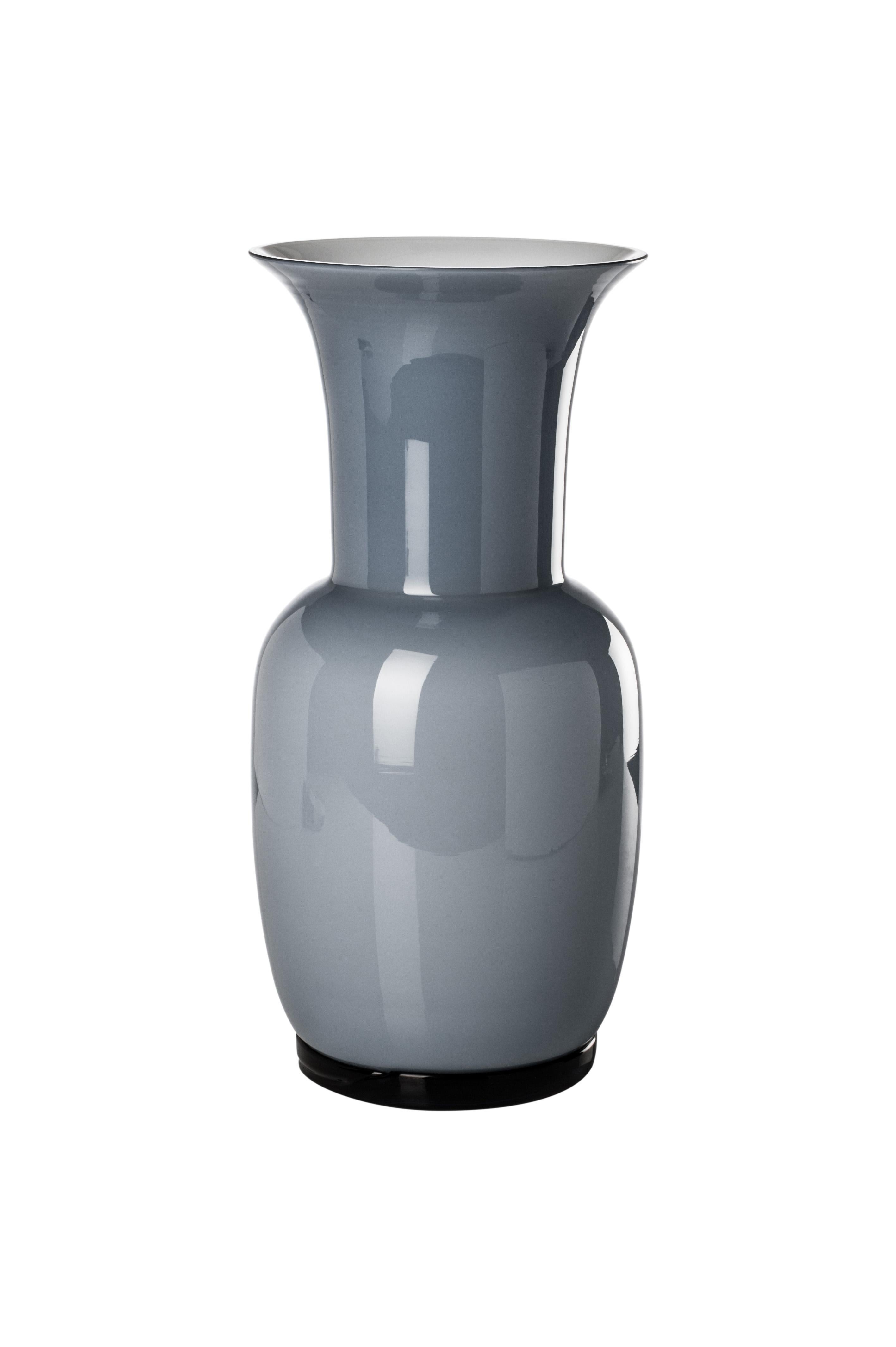 Venini glass vase with slim, oval shaped body and funnel shaped neck. Featured in aquamarine colored glass. Perfect for indoor home decor as container or strong statement piece for any room.

Dimensions: 17 cm diameter x 36 cm height.