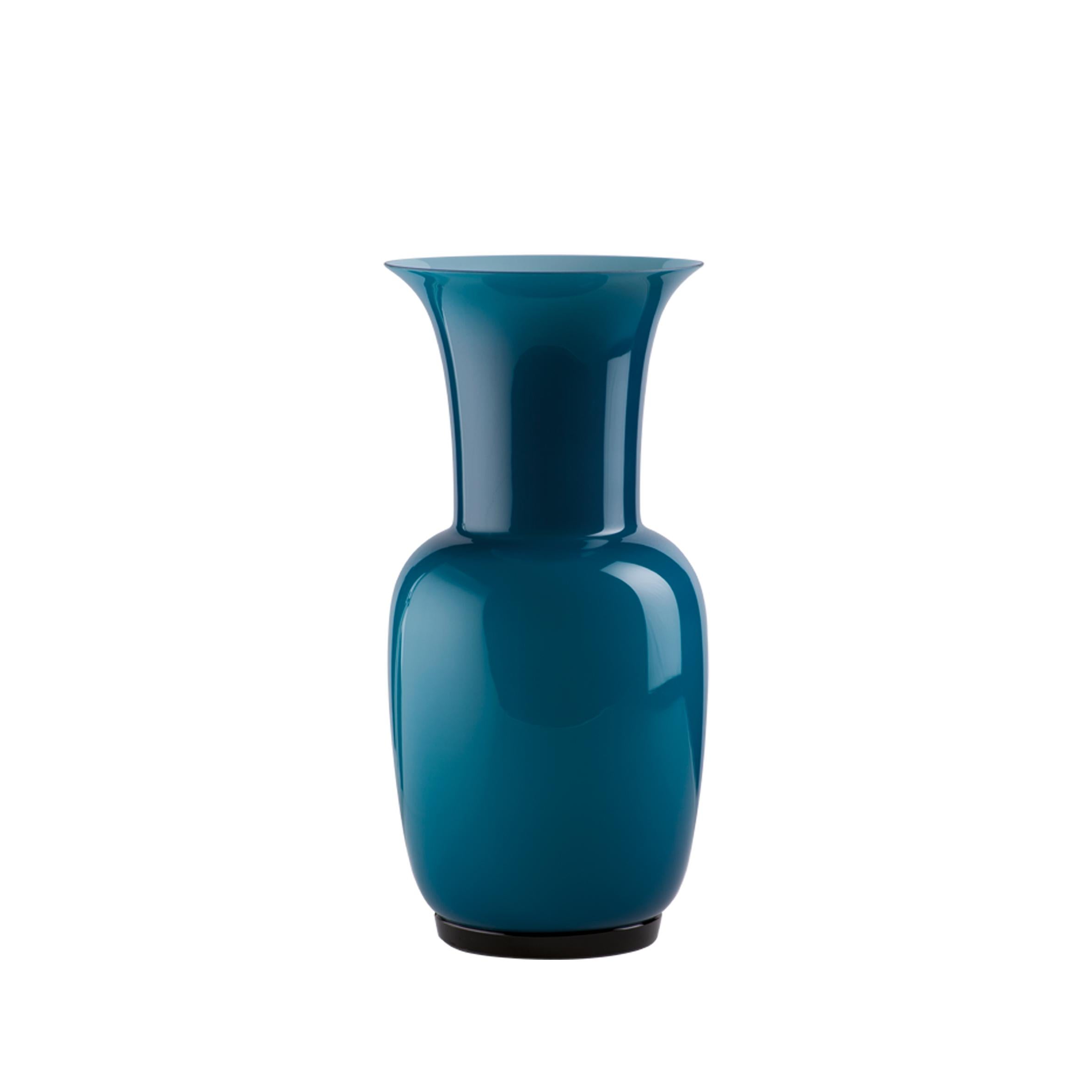 Venini glass vase with slim, oval shaped body and funnel shaped neck. Featured in aquamarine colored glass. Perfect for indoor home decor as container or strong statement piece for any room.

Dimensions: 17 cm diameter x 36 cm height.