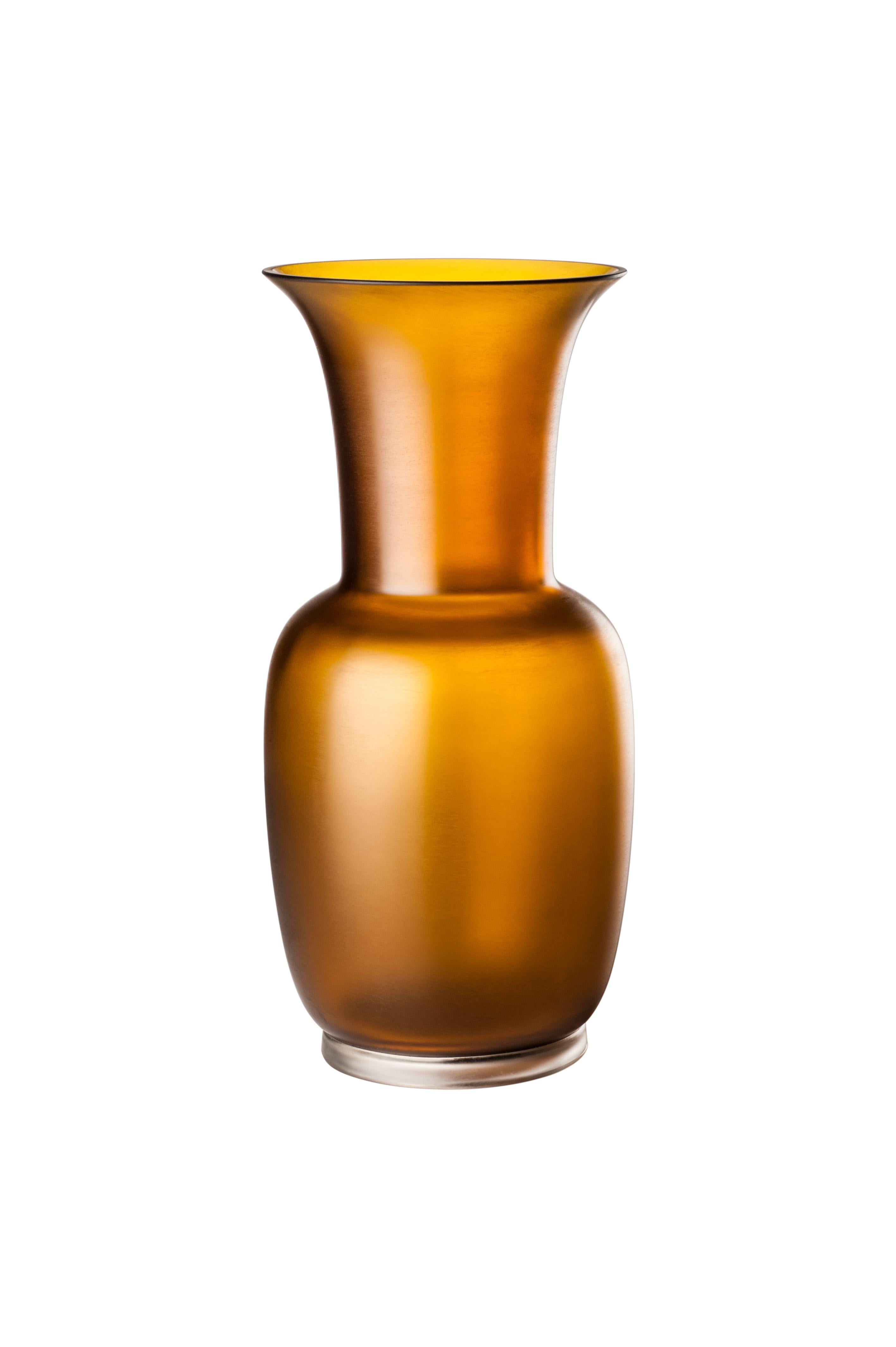 Venini glass vase with slim, oval shaped body and funnel shaped neck. Featured in tea and crystal colored glass. Perfect for indoor home decor as container or strong statement piece for any room.

Dimensions: 17 cm diameter x 36 cm height.