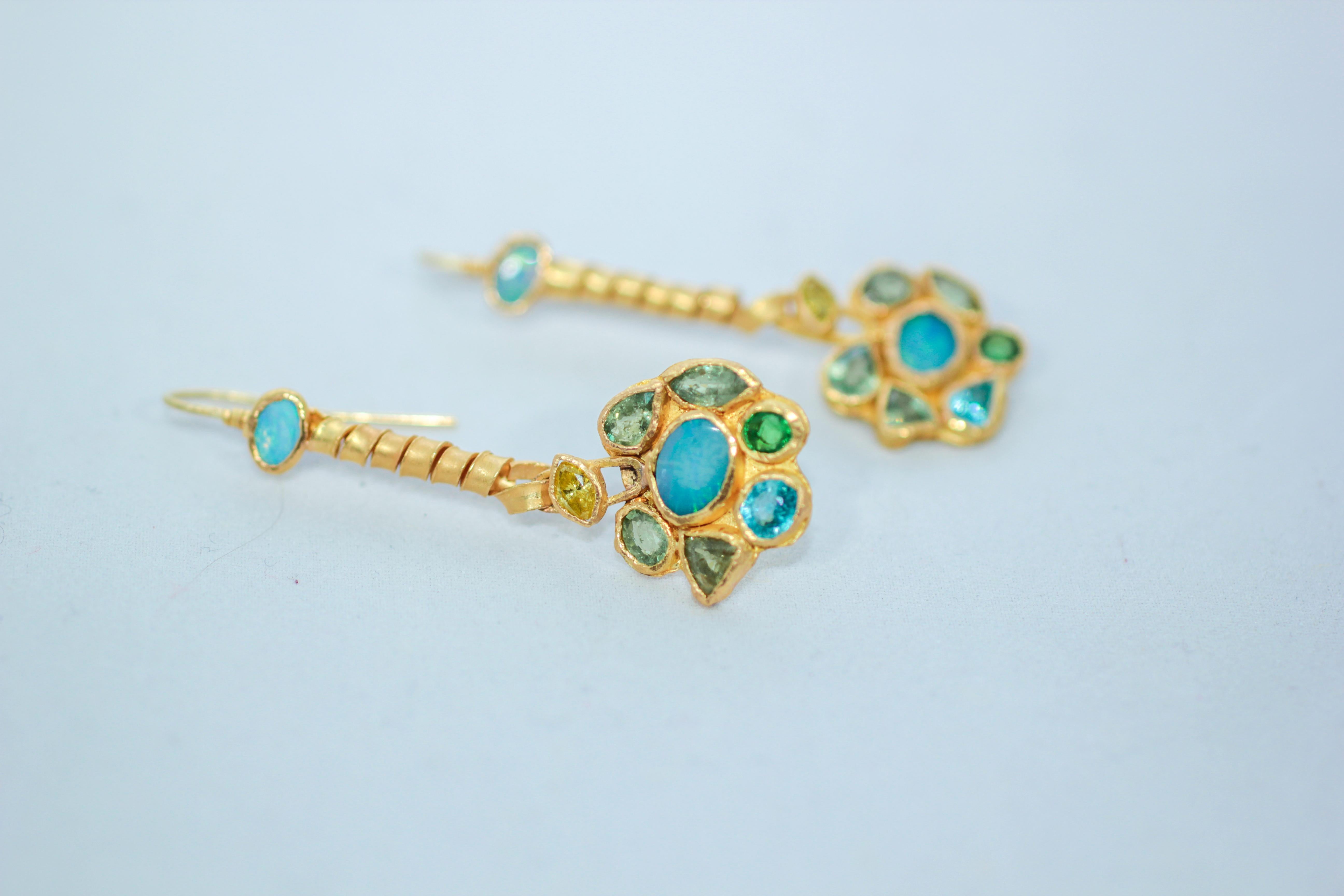 Forget-Me-Not flowers dangle drop earrings. Opals, yellow diamonds, demantoid garnets, zircons are bezel set in 21K gold. One-of-a-kind, handmade. Beautiful sparkle and intense blue-green-yellow colors. Feminine and elegant, these will surely start