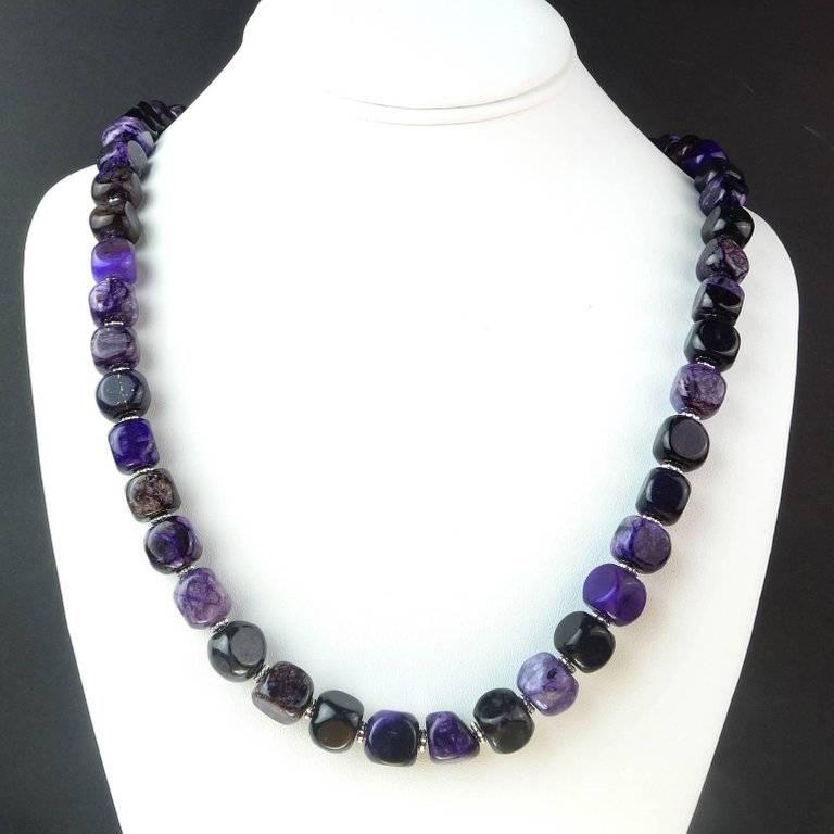 24.5 Inch necklace of softly rounded, Amethyst matrix cubes, approximately 9MM. Each cube is unique in intensity of color and matrix. The Amethysts are enhanced with fluted silver tone accents. The clasp is a Sterling Silver hook and eye. 