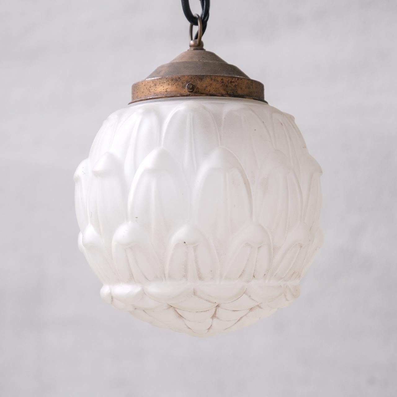 An opaque glass pendant light.

France, c1930s.

Artichoke shaped glass.

Metal gallery.

No rose was retained or chain, however they are easy to source online.

Good vintage condtion, re-wired and PAT tested.

Location: Belgium