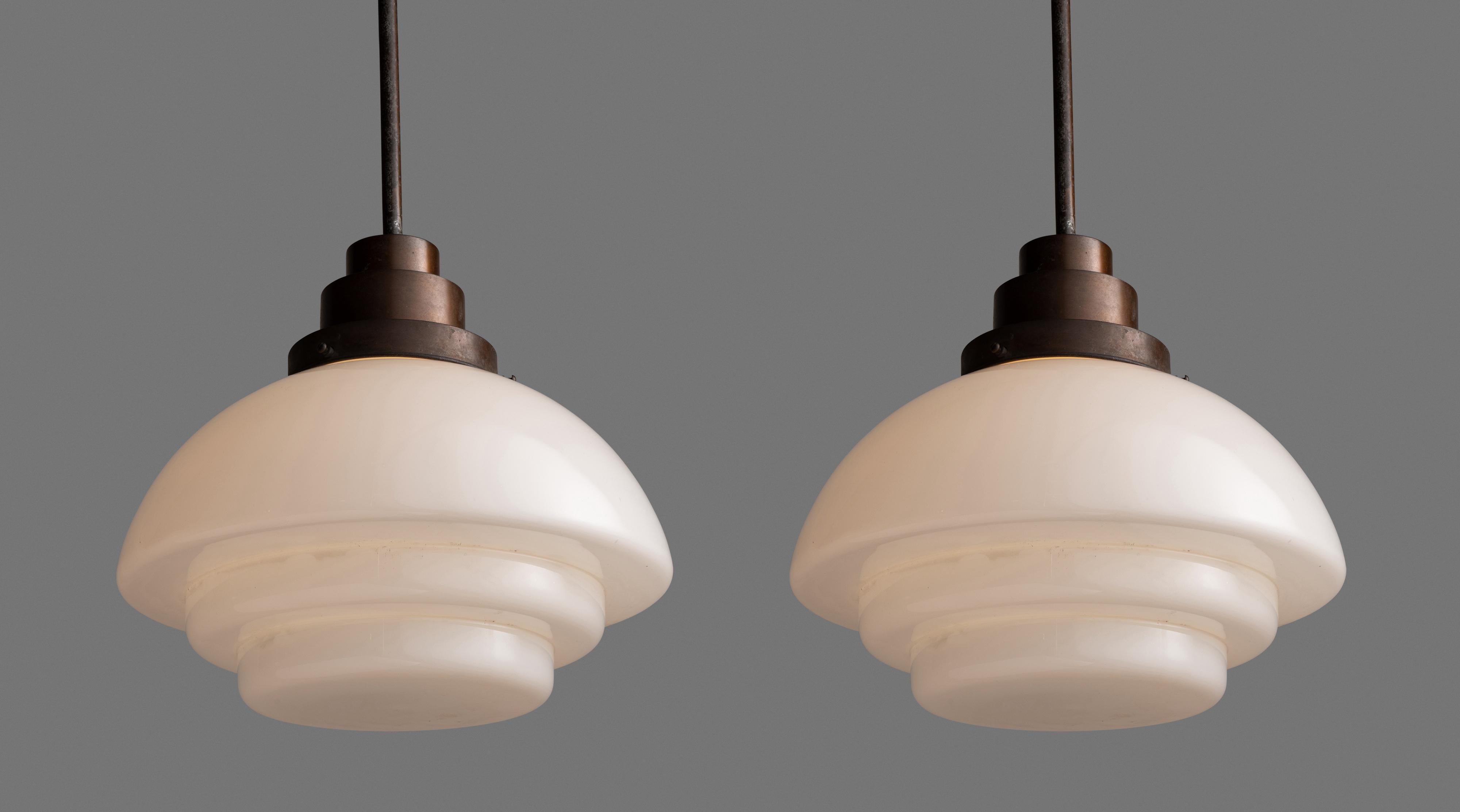 Opaque deco ceiling lights.

England circa 1930

Tiered opaline glass shades with copper fitter and rod.

*Please note the price is per unit, and the lights are sold individually*