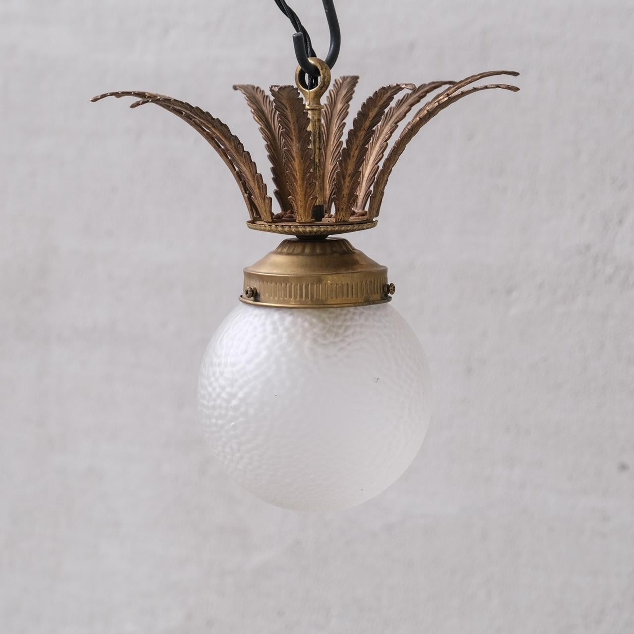 A brass and glass pendant light.

Unusual brass leaf gallery.

Playful and decorative.

France, c1950s.

No chain or rose was retained, however they are easy to source online.

Good vintage condtion, re-wired and PAT tested.

Location: Belgium