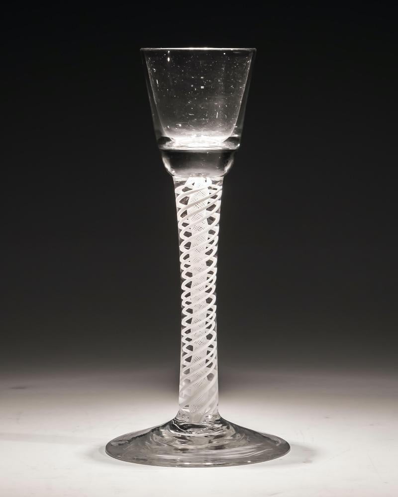 An opaque twist cordial glass.

England, circa 1760.

Measures: Height: 16 cm (6 1/4