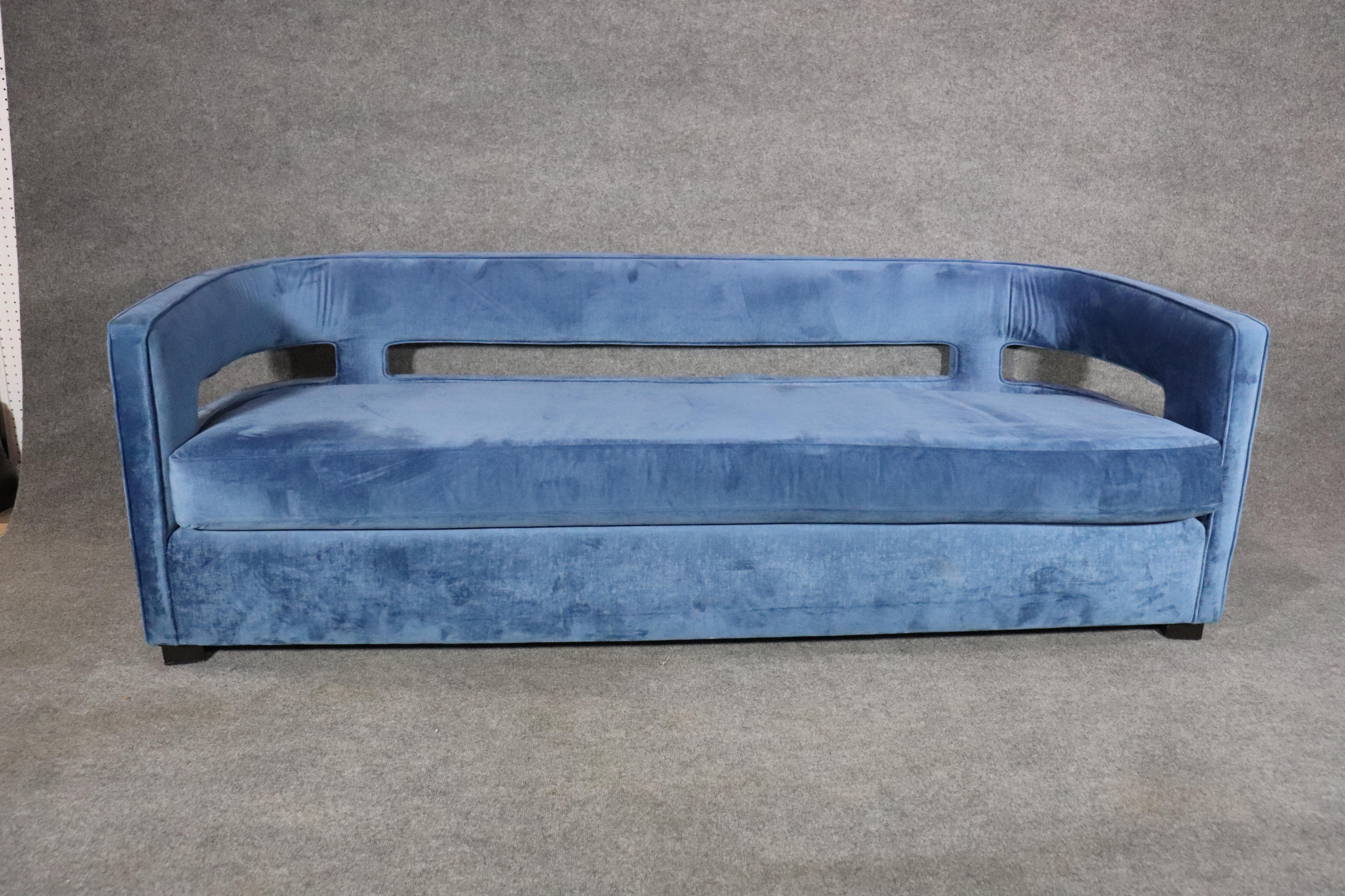 Modern satin sofa with an open curved back. Beautiful blue velvet fabric with mid-century modern style.
Please confirm location.