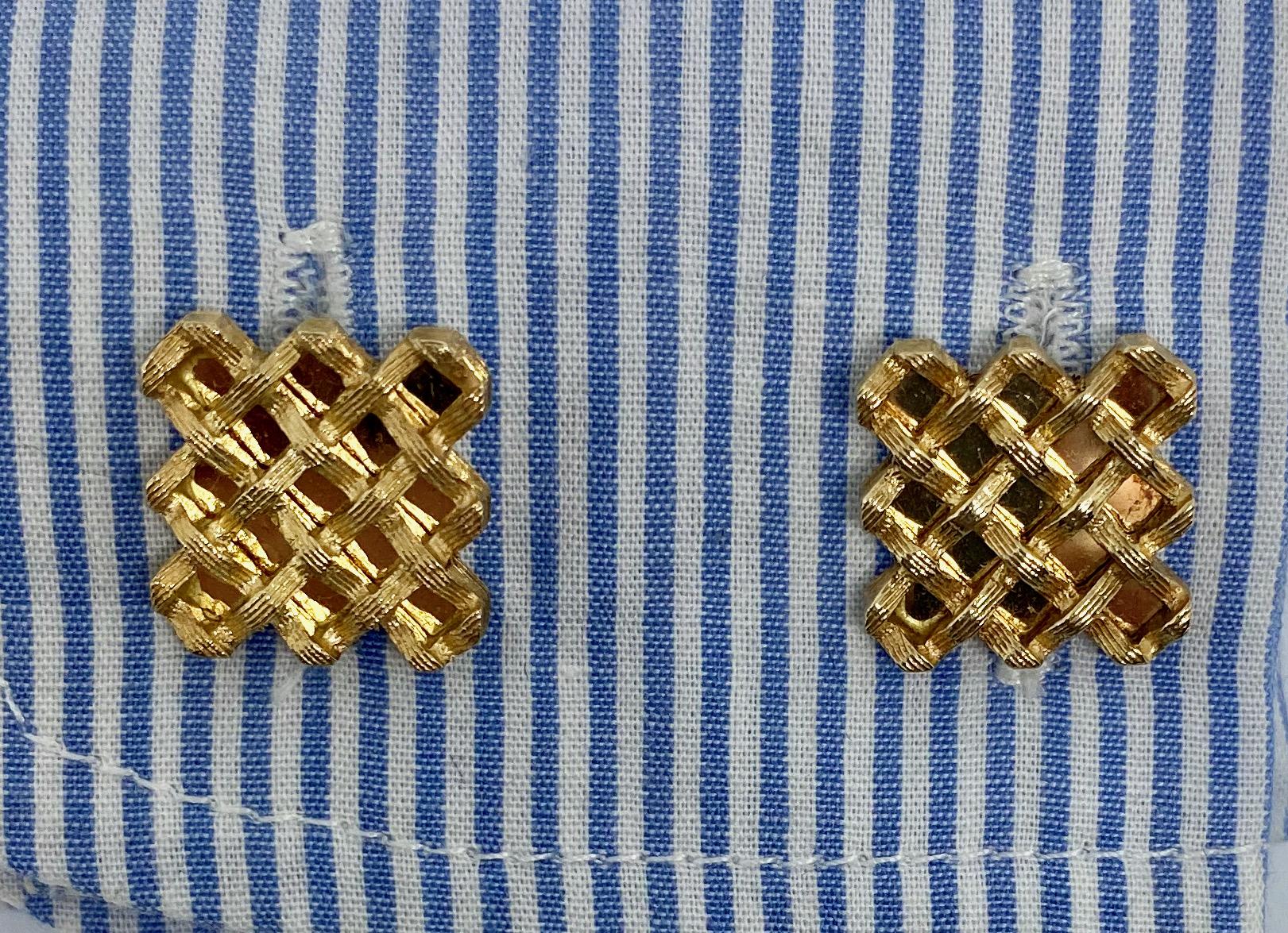 A pair of cufflinks featuring a handsome open basketweave pattern in 14K yellow gold.

The gold on the faces and backs has been painstakingly hand-engraved; the workmanship is excellent. The toggle backs have a good, firm snap, making the cufflinks