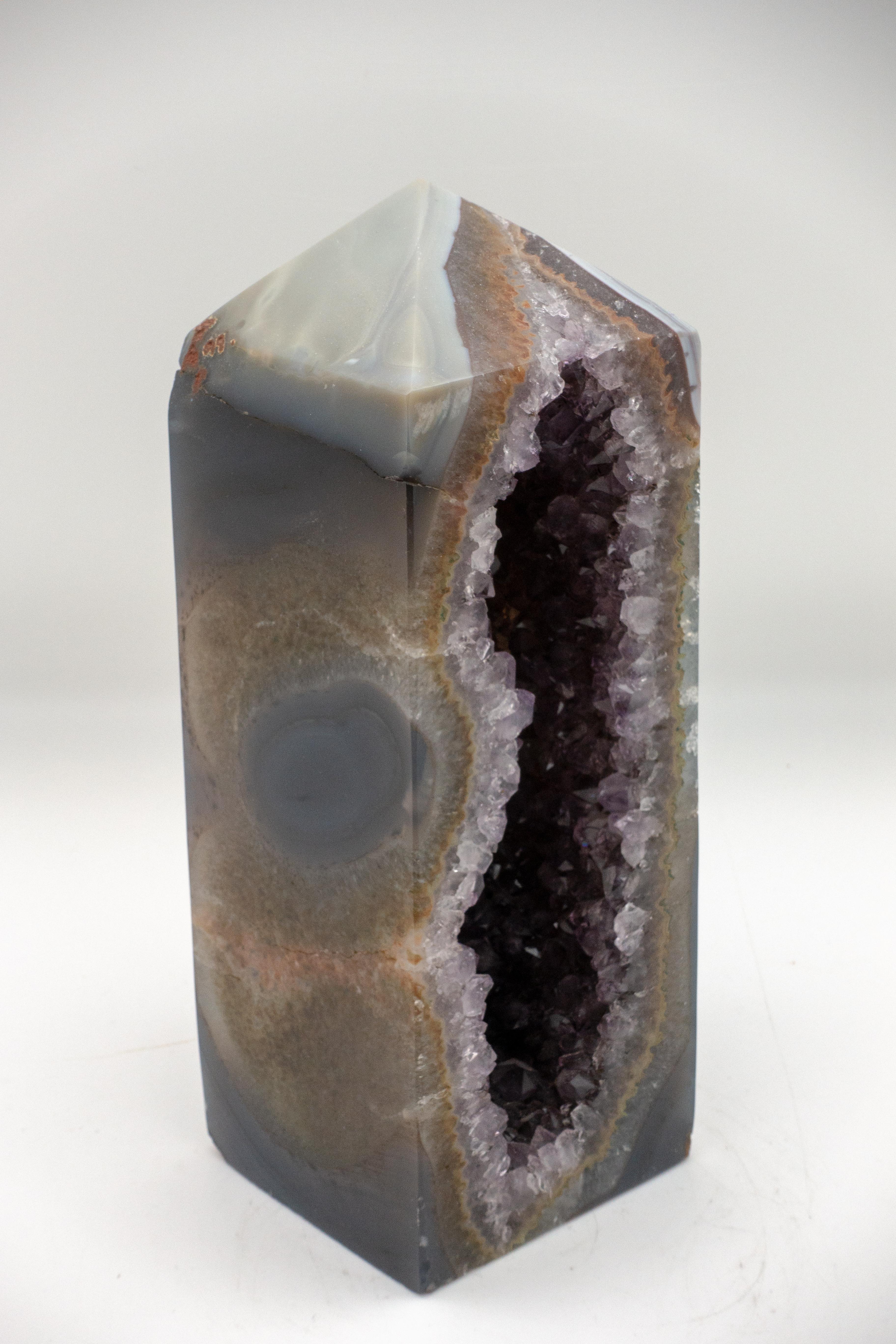 This mineral obelisk is open from front to back with agate on the outside and amethyst on the inside.