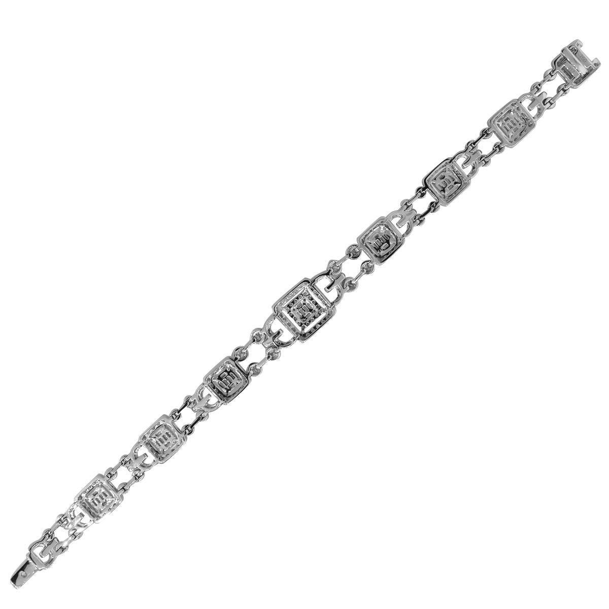 Material: 18k White Gold
Diamond Details: Approximately 3.52ctw of round brilliant diamonds and approximately 0.95ctw baguette cut diamonds. Diamonds are G/H in color and VS in clarity
Wrist size: Will fit up to a 7″ wrist
Measurements: 0.48″ in