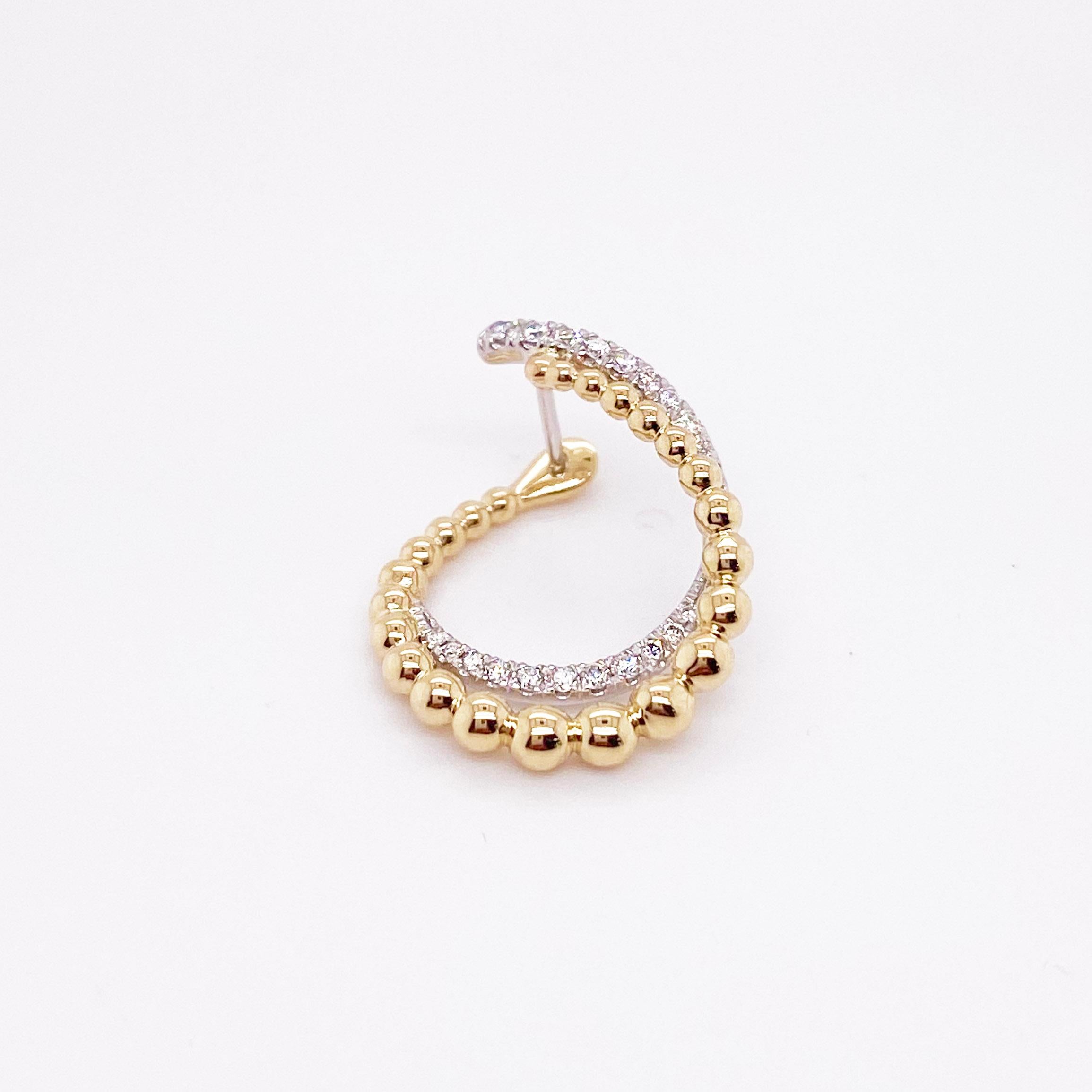 The fun, modern earrings have a very unique design with a gold beaded texture and bright white diamonds! The design appears to be in motion with the beaded row and diamonds wrapping around in a circle together. The earrings are made with genuine