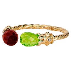 Open ended peridot, garnet 14k gold ring. 