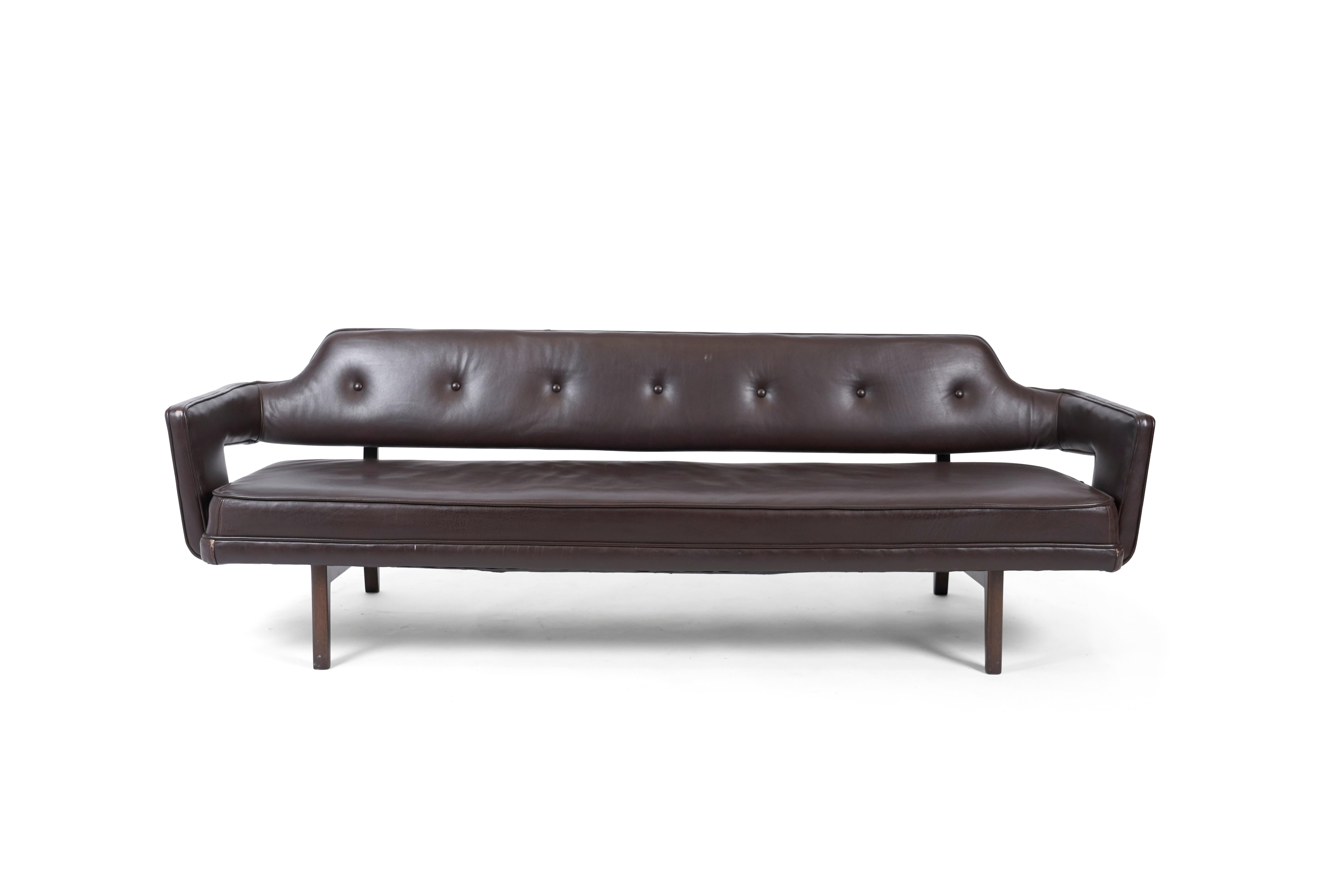 Exposed bracket frame sofa by Edward Wormley for Dunbar, circa 1960s. Leather is in great condition, as is the mahogany frame, which is finished in a dark walnut tone.
