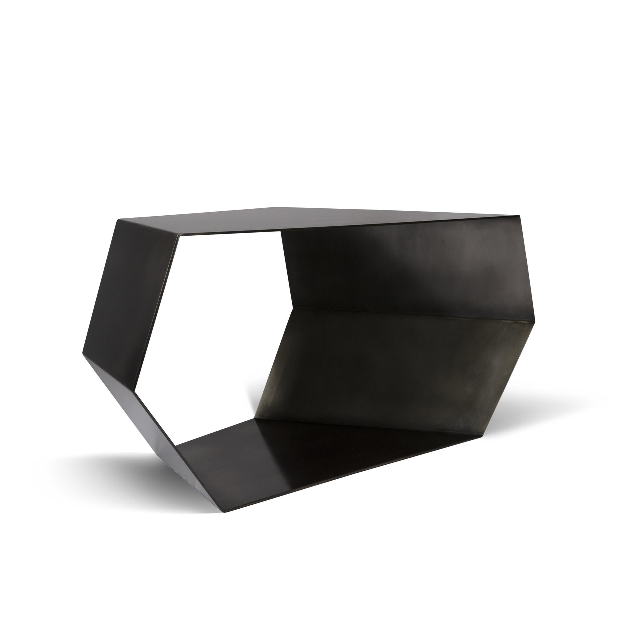 The open geo table is a striking yet Minimalist display or center table. Solid steel fabrication with a contemporary blackened finish, the open form plays with themes of transparency and mass and is a perfect statement table for residential or