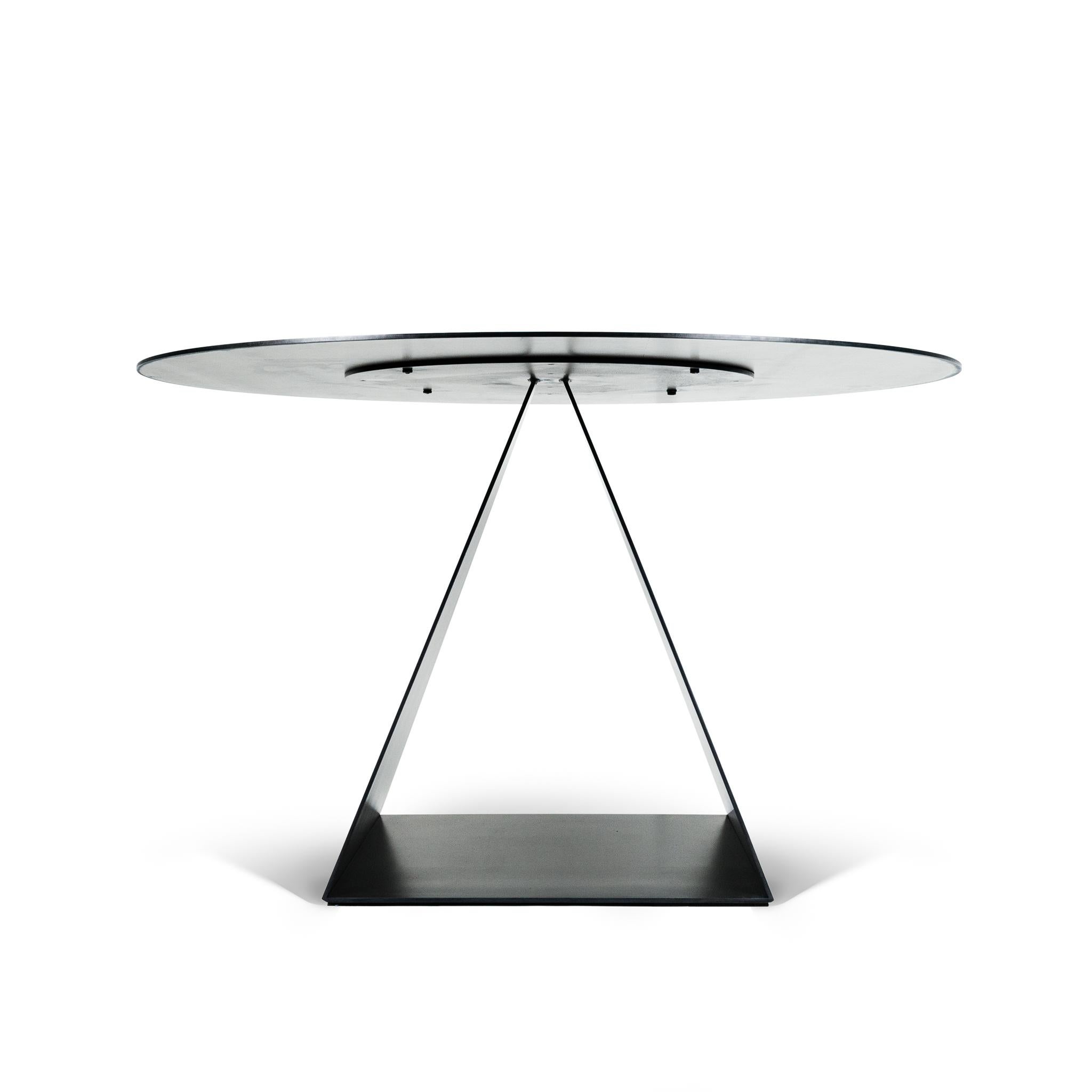 The Trillion table is a show stopping statement Table! It pedestal open triangle base is Simple yet Dramatic that plays with negative space. Hand Fabricated and Finished by hand with a modern blackened steel finishing process. 

Customization-Table