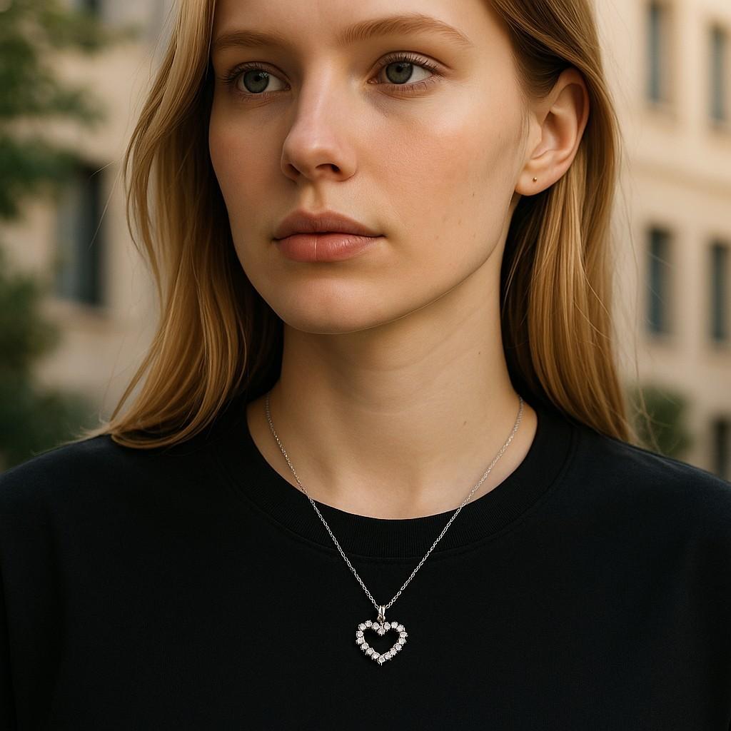 Introducing a timeless and elegant piece for your discerning clientele: the Vintage 18 Karat White Gold Open Heart Diamond Pendant Necklace. Crafted with exquisite attention to detail, this pendant necklace features a captivating open heart design
