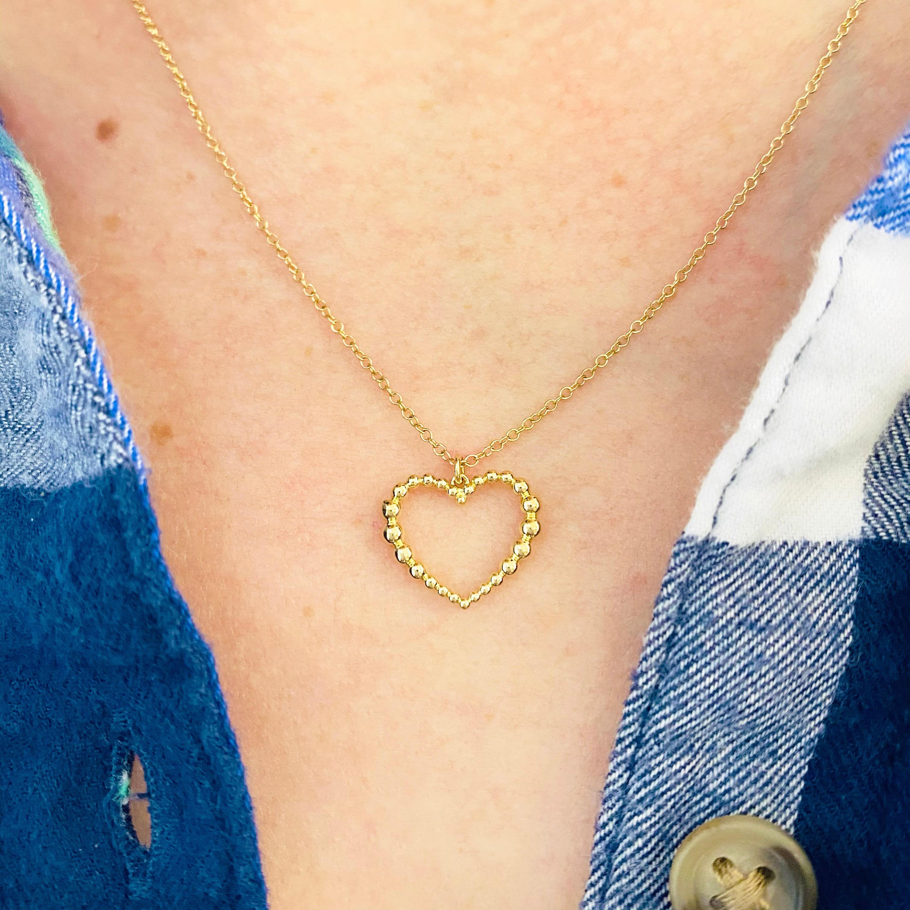 This gorgeous petite 14k yellow gold open heart pendant is sure to put a smile on anyone's face! This necklace looks beautiful worn by itself and also looks wonderful in a necklace stack. The beads on this necklace are three dimensional as they go