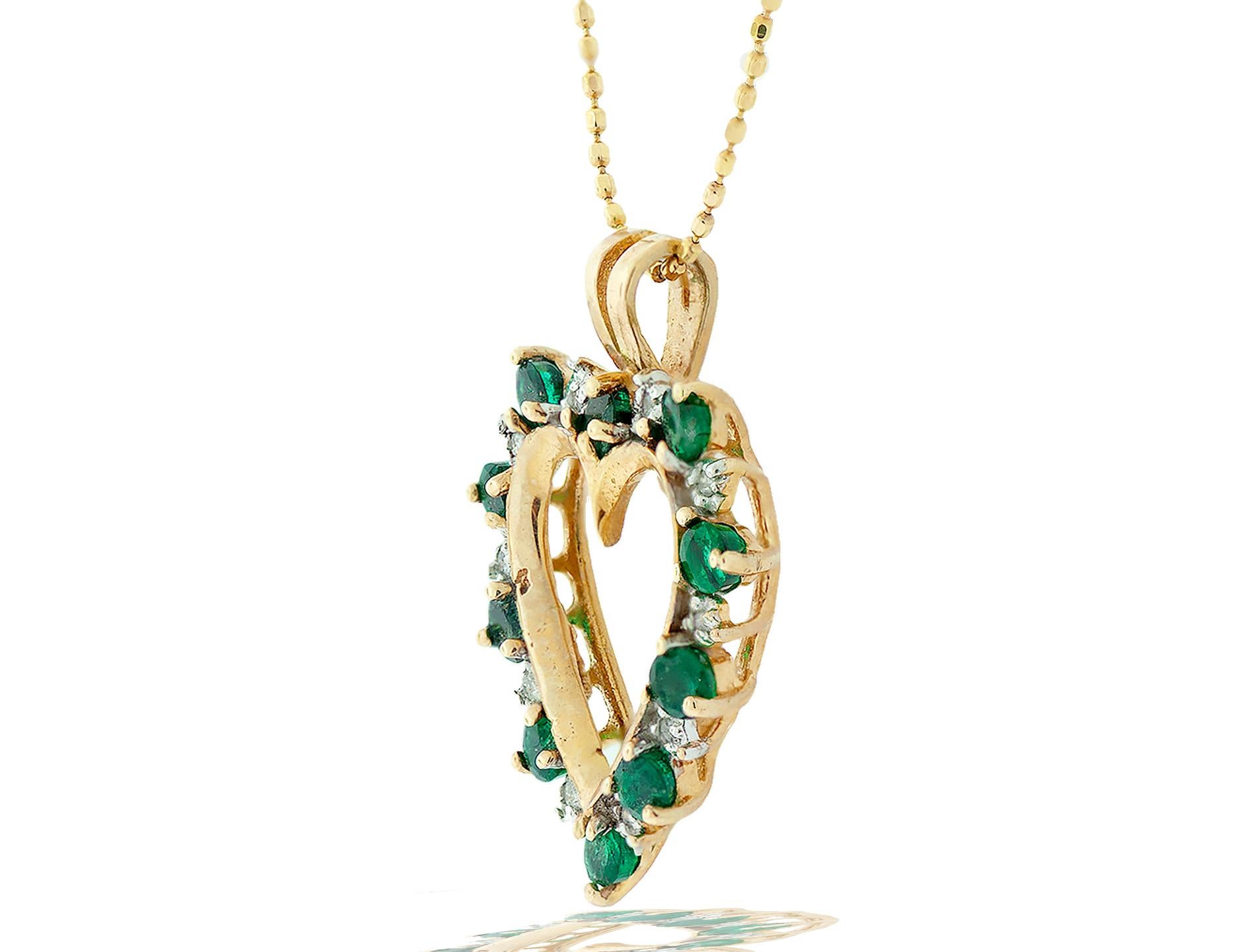 Pristine, Alternating gemstones of Emeralds and Diamond on an Open Heart Pendant with gold Chain
The 1