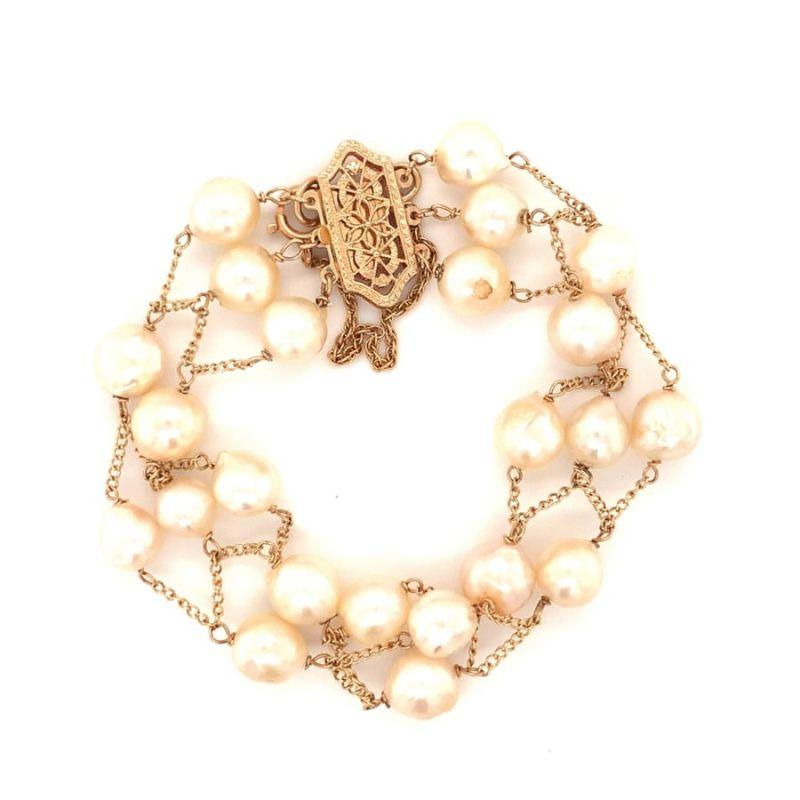 One open link pearl 14K yellow gold flexible bracelet featuring a total of 23 round cultured white pearls measuring 7.5 millimeters in average diameter. Circa 1960s.

Precious, enchanting, sweet.

Additional information:
Metal: 14K yellow
