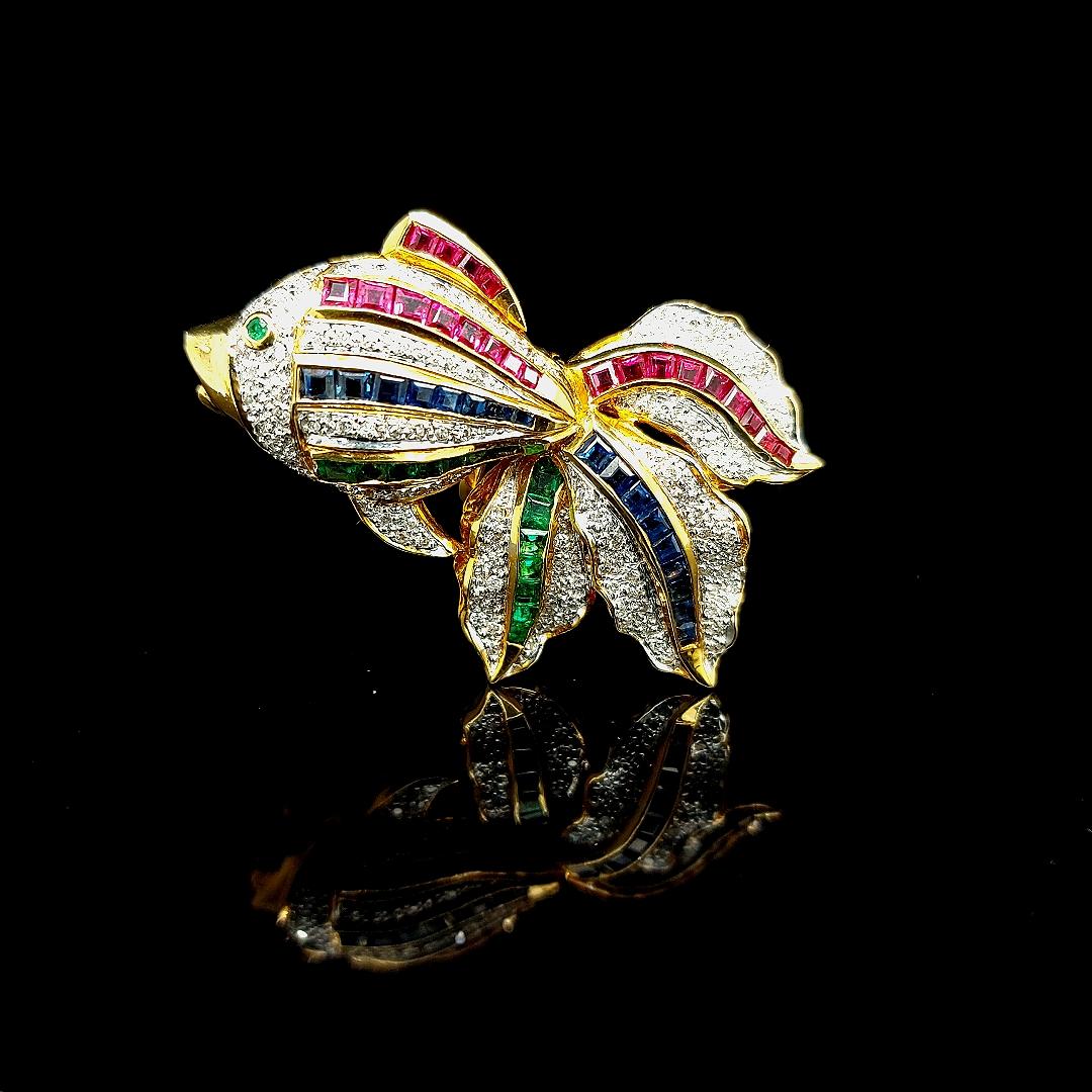 Open Mouth Fish Brooch / Pendant Set With Diamonds, Ruby , Sapphire, Emerald 

Attached to the jewel is a hinge to be used as a pendant when wanted.

Diamonds: 133 brilliant cut diamonds ,ca. 0,66 ct

Ruby: 21 square cut rubies ca. 1,05