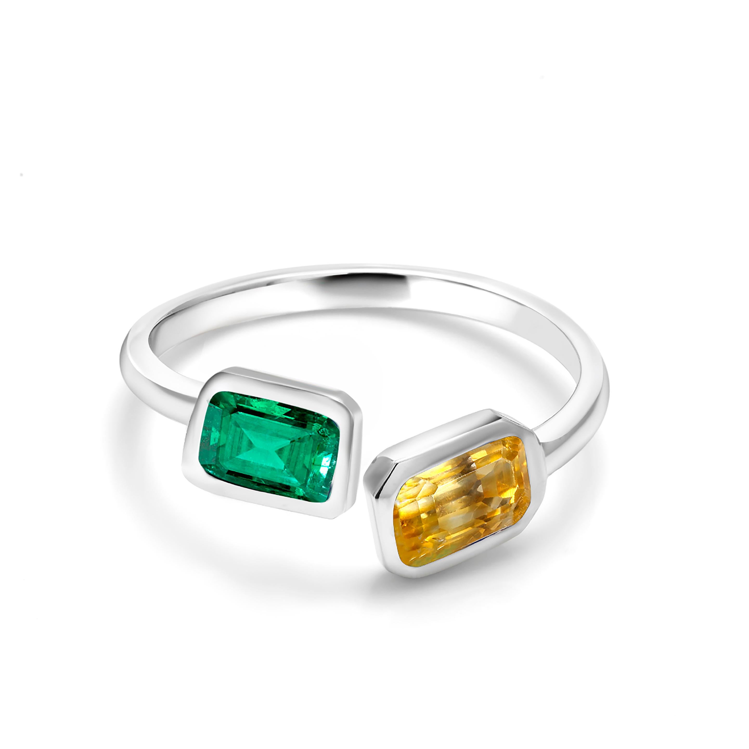 Fourteen karats white gold open shank bezel set cocktail ring
Emerald cut shape emerald measuring 7x5 millimeter and weighing 0.65 carat
Emerald cut yellow sapphire measuring 7x5 millimeter and weighing 0.95 carat
Ring size 6
New Ring
The ring can