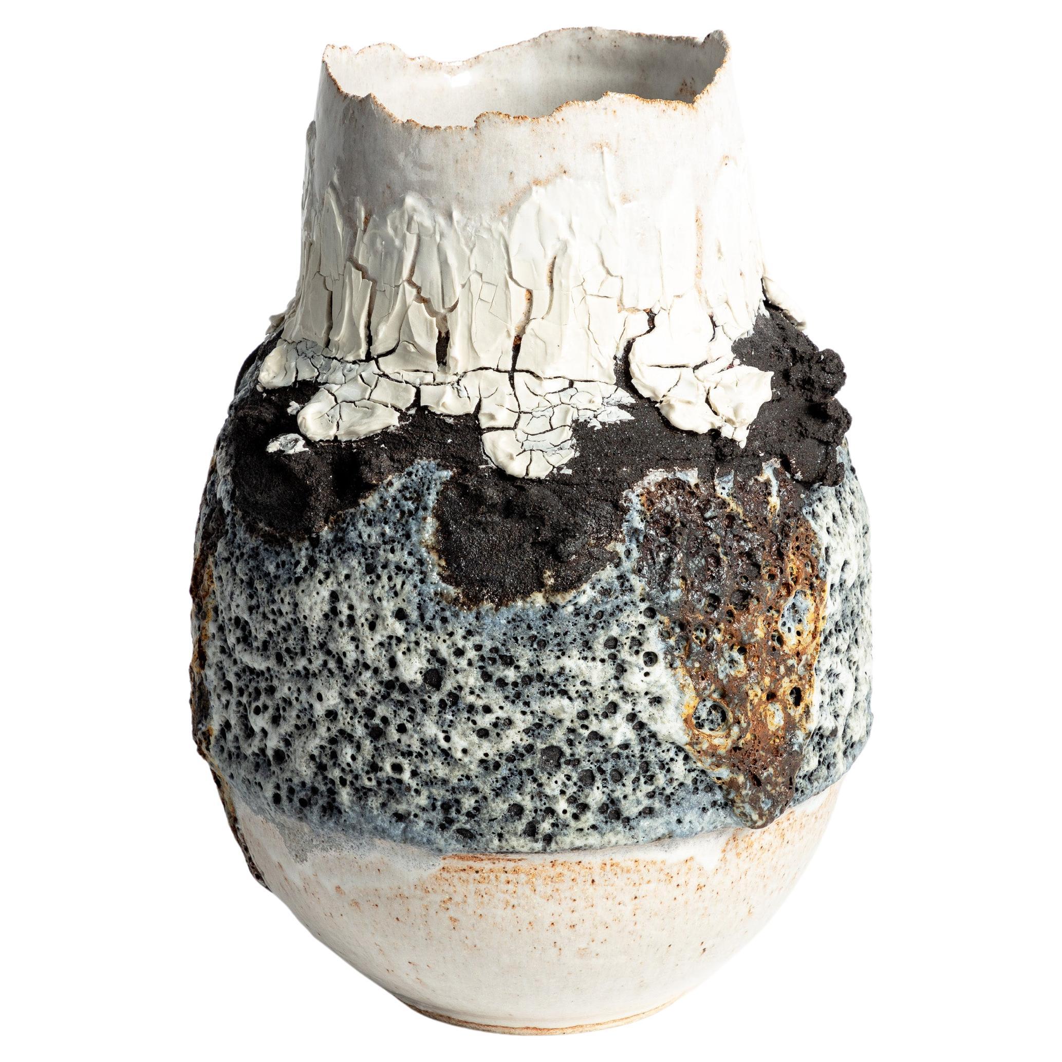 Open volcanic textured vase with cracked porcelain and lava stone